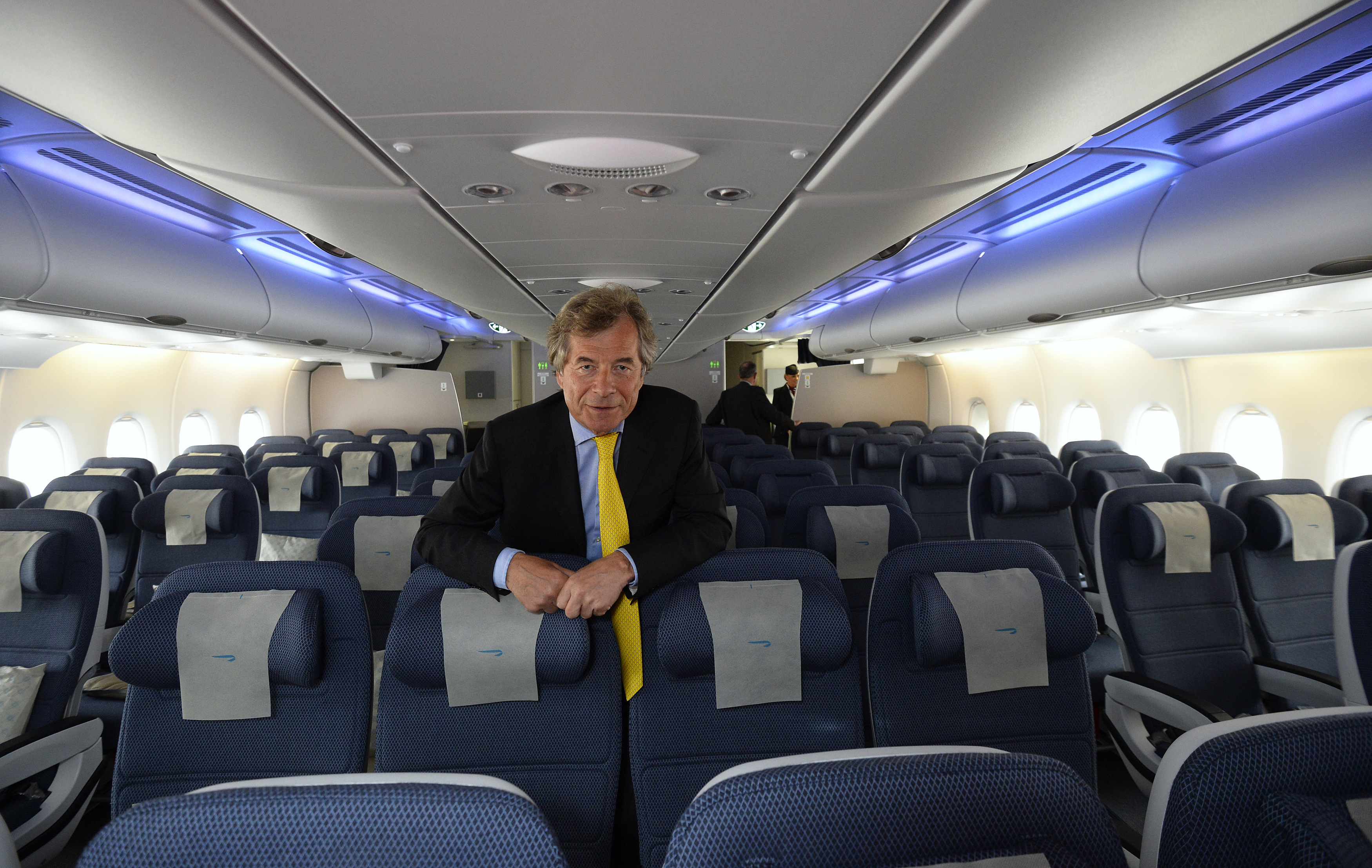 British Airways Chairman, Martin Broughton, poses for photographs in the world traveller cabin of the British Airways Airbus A380 at Heathrow airport in London