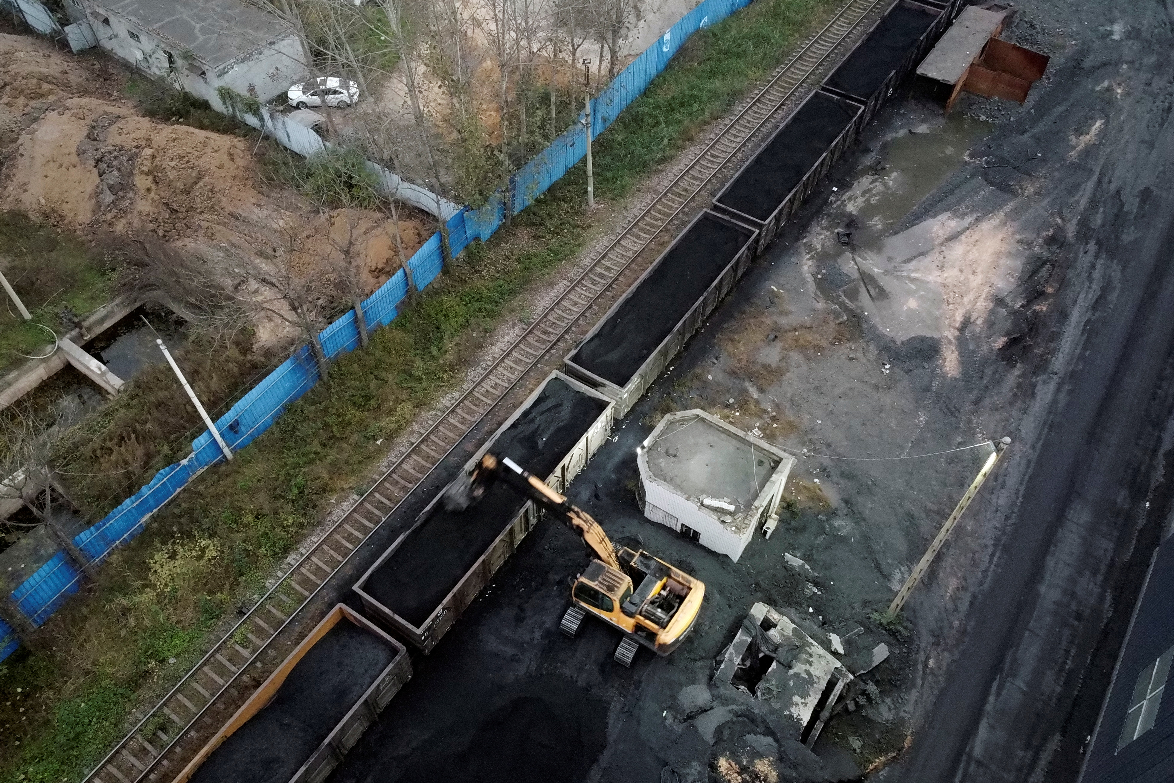 An excavator loads coal onto a train in Pingdingshan, Henan province
