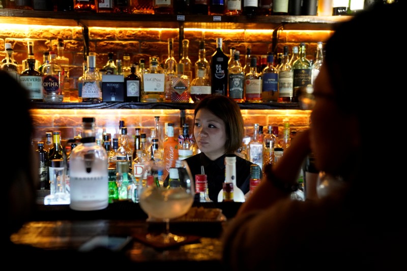 A bartender works at a bar in Shanghai