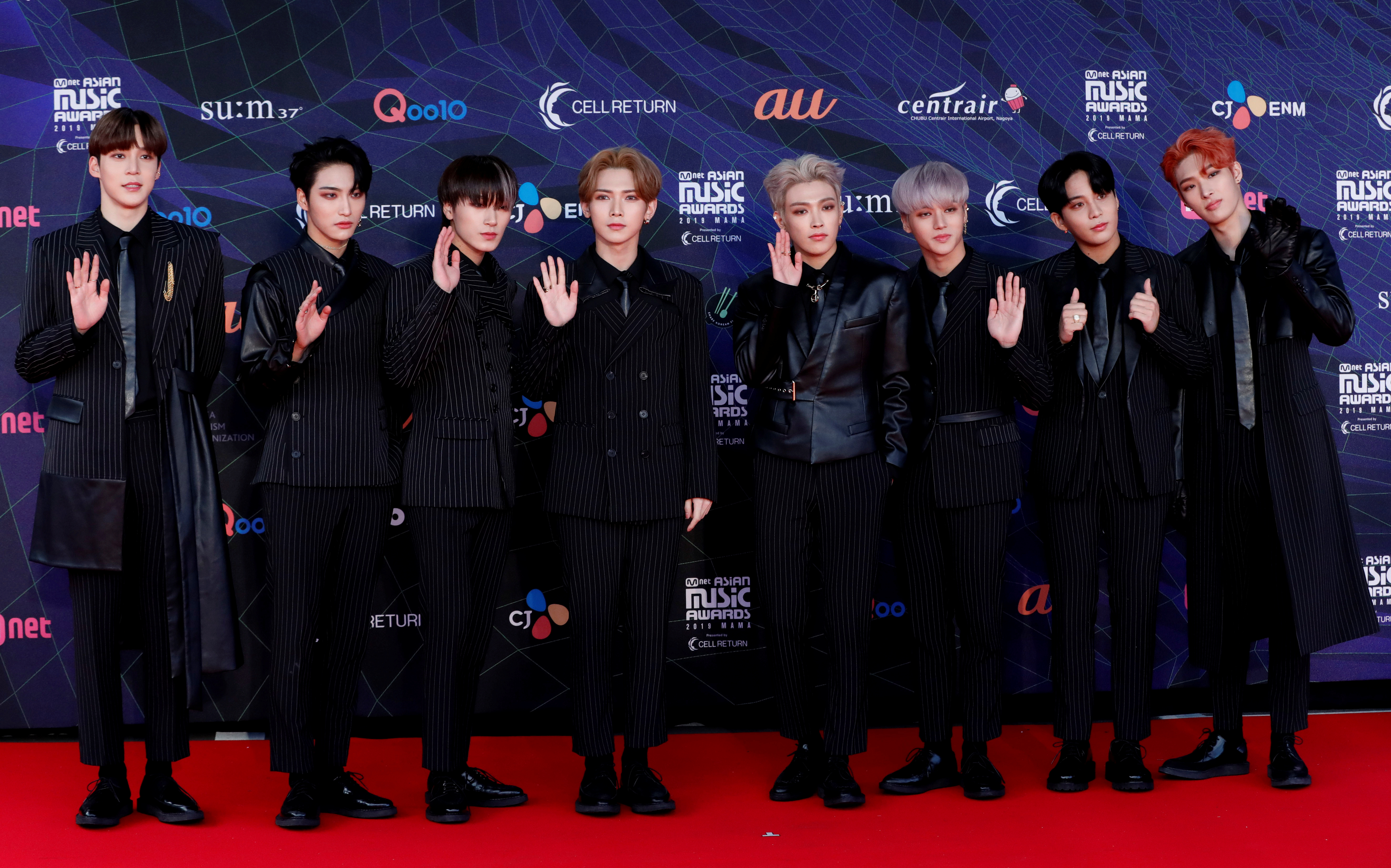 Members of South Korean boy band ATEEZ pose on the red carpet during the annual MAMA Awards at Nagoya Dome in Nagoya,