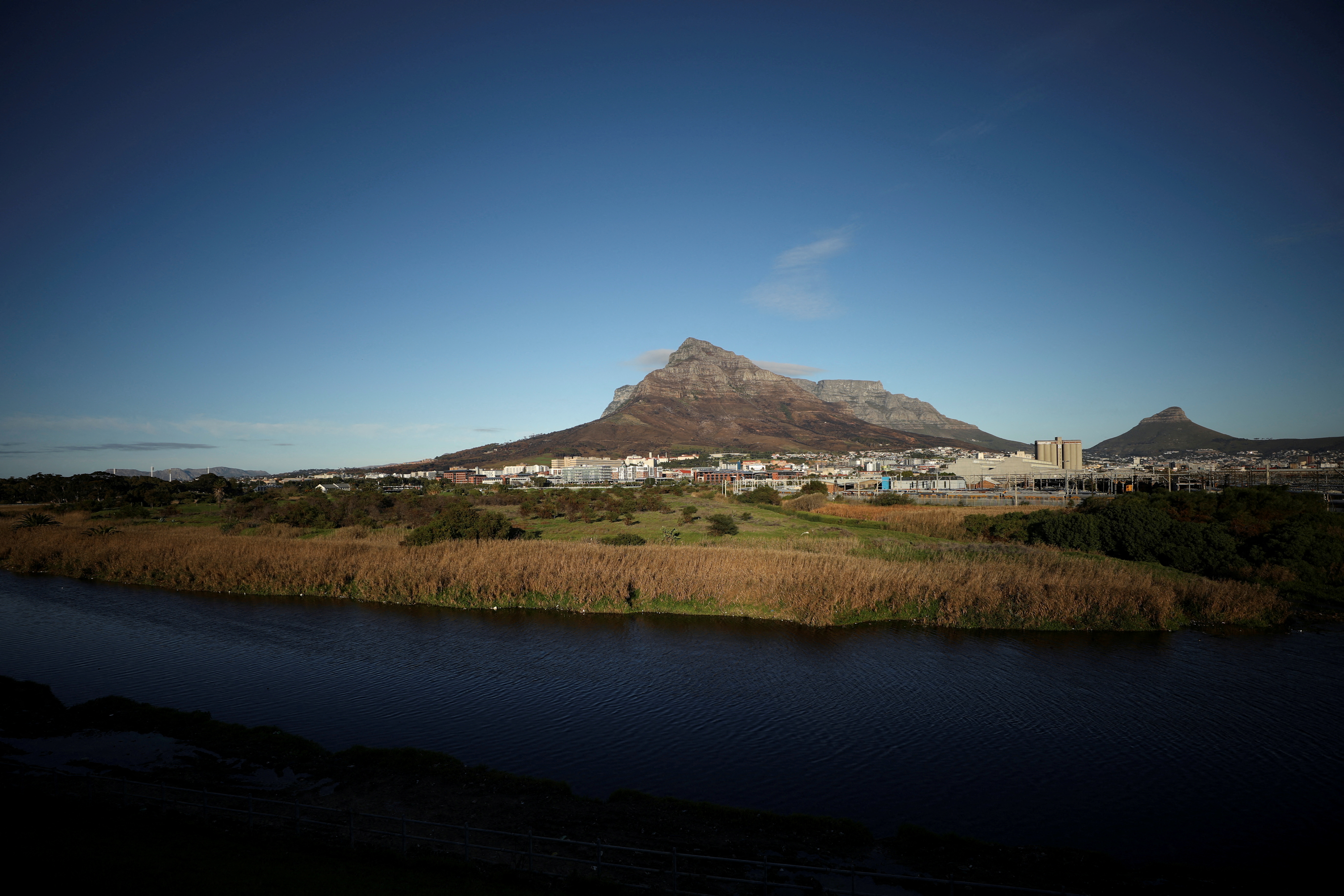 Contested land earmarked for a development which includes a new Africa headquarters for U.S. retail giant Amazon is seen alongside the Black River in Cape Town