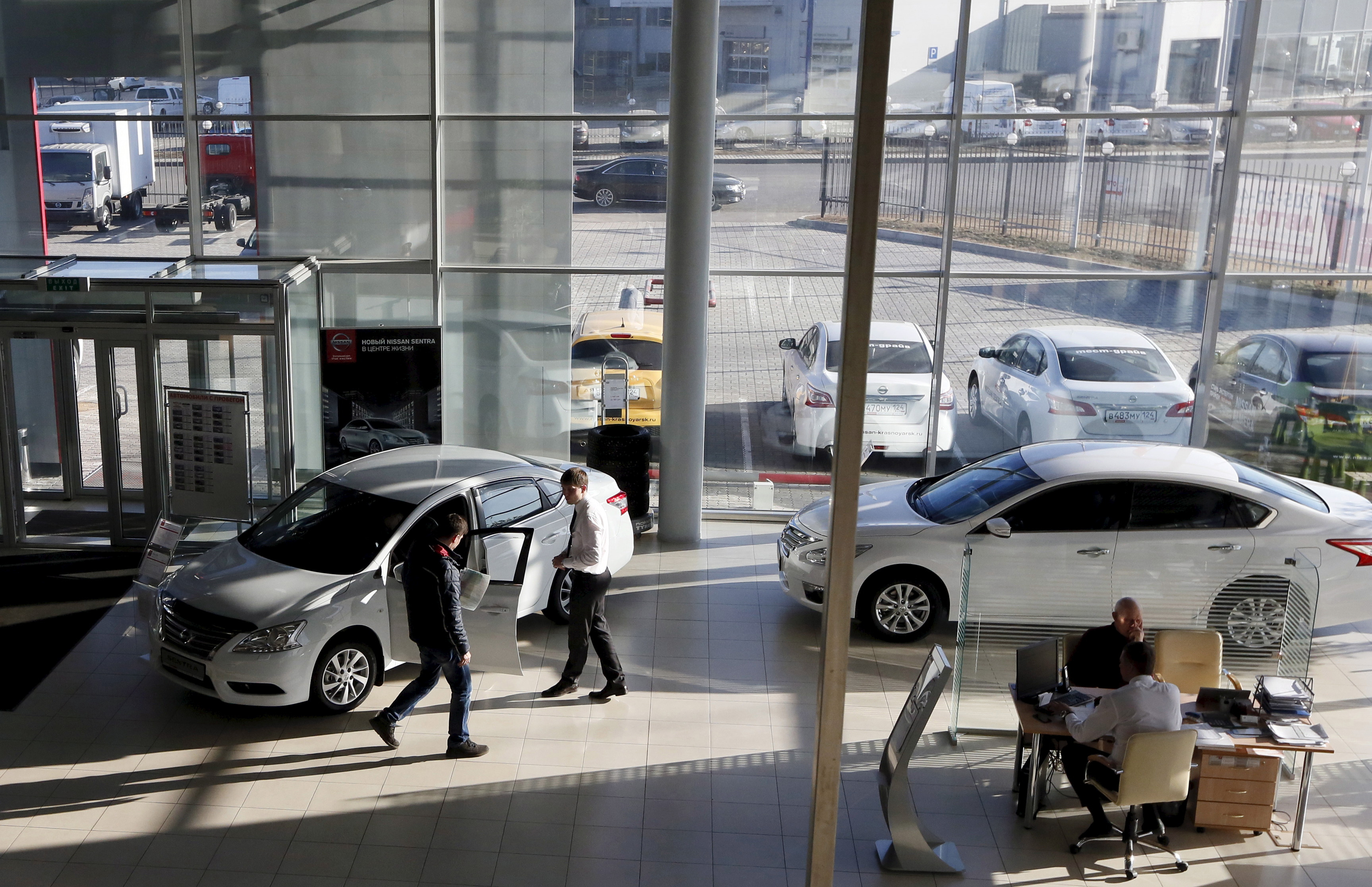 Employees talk with customers at Nissan and Datsun showroom in Krasnoyarsk