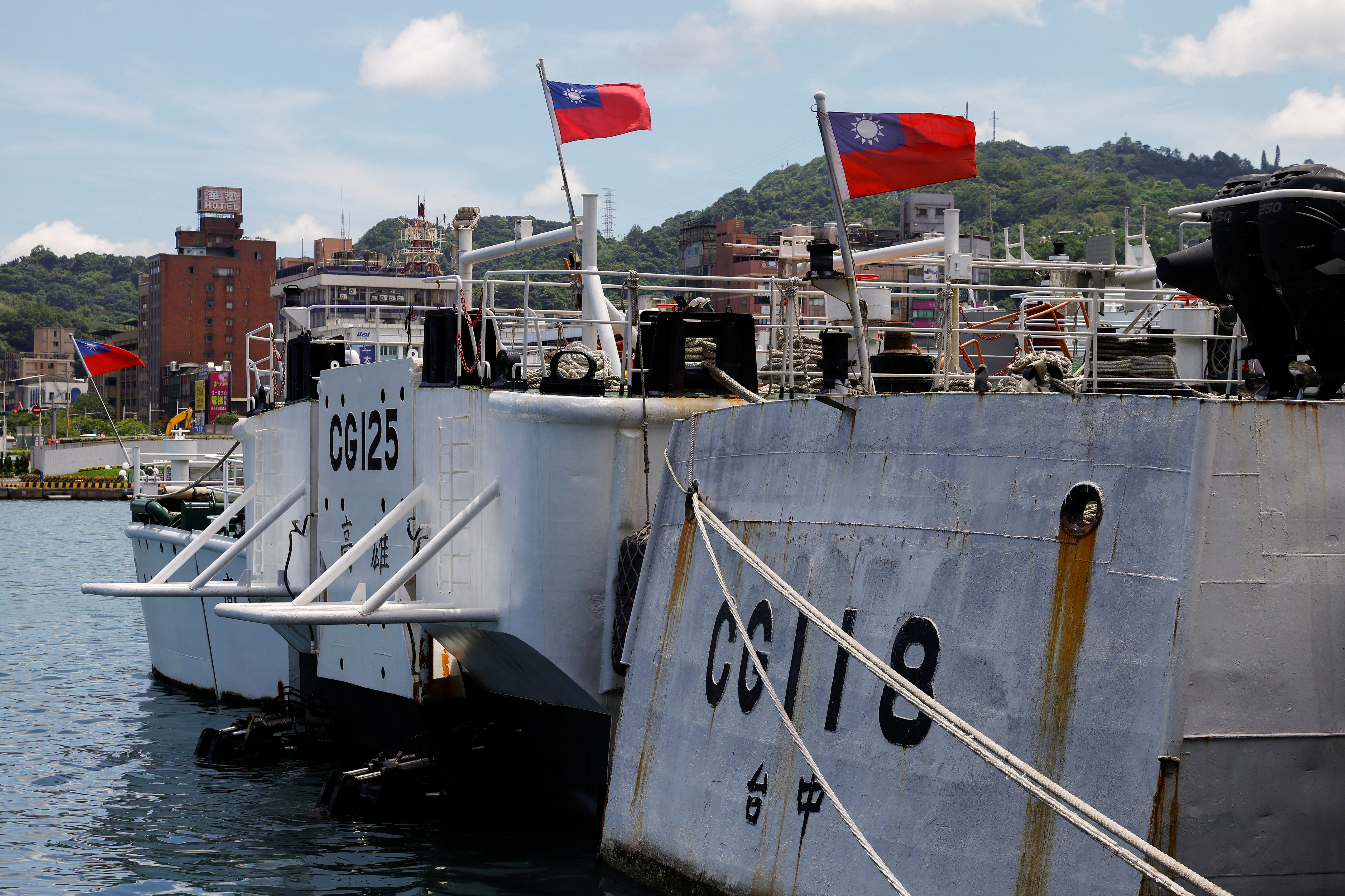 Taiwanese flags flutter on ships parked at a port in Keelung