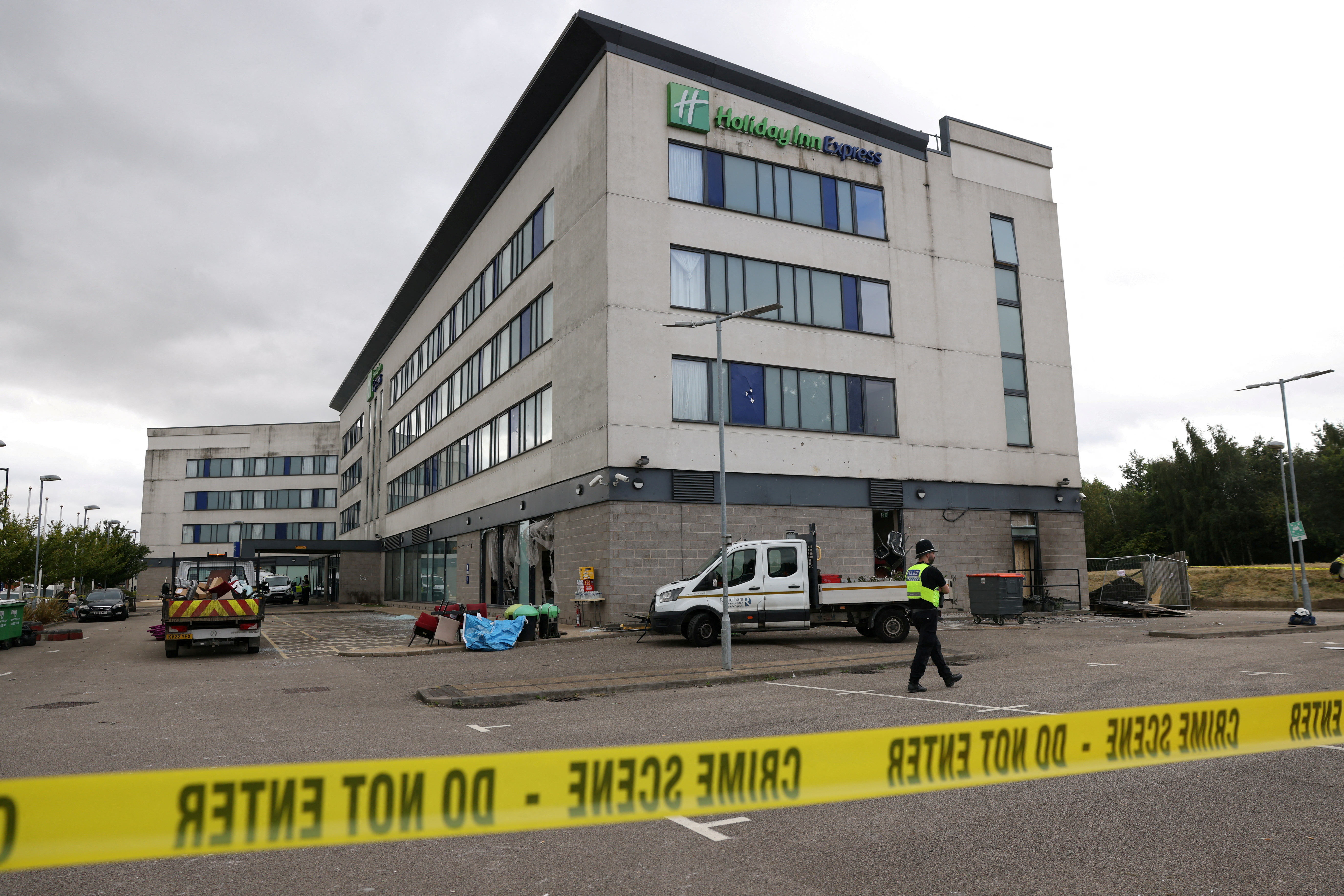 Clean up outside the Holiday Inn Express after rioters attacked the hotel in Rotherham