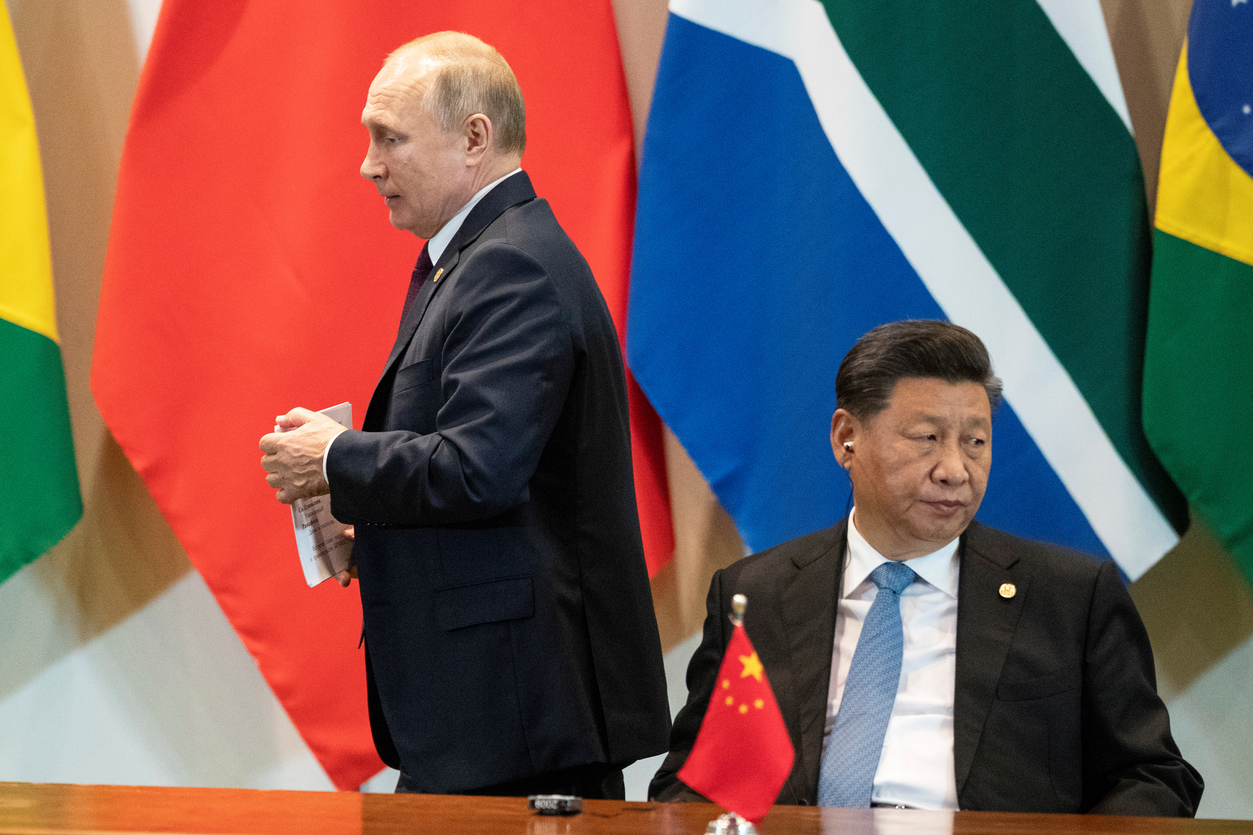 China's President Xi Jinping and Russia's President Vladimir Putin attend a meeting with members of the Business Council and management of the New Development Bank during the BRICS emerging economies at the Itamaraty palace in Brasilia