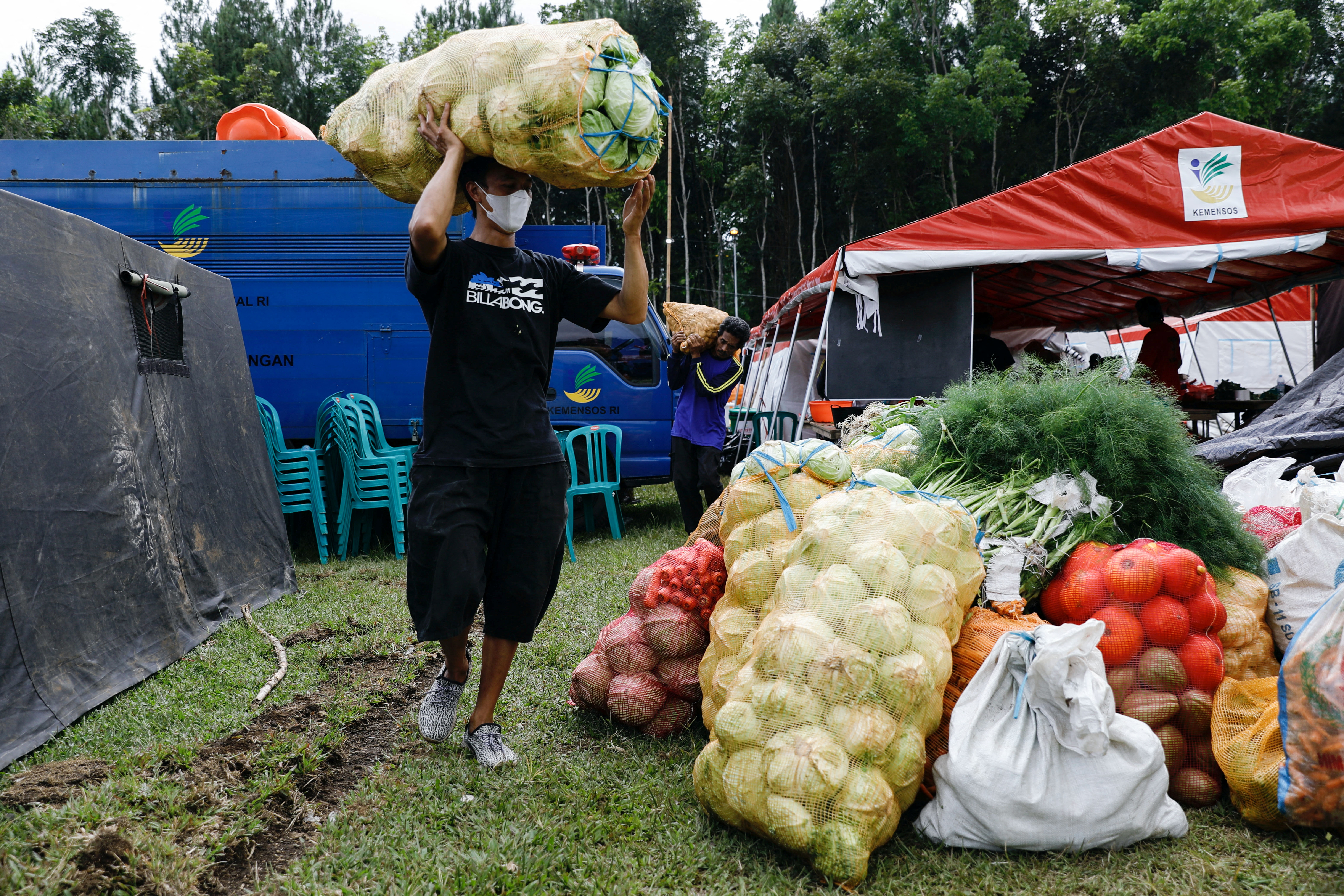 Volunteers load vegetables at a temporary shelter in Penanggal, Candipuro district, Lumajang