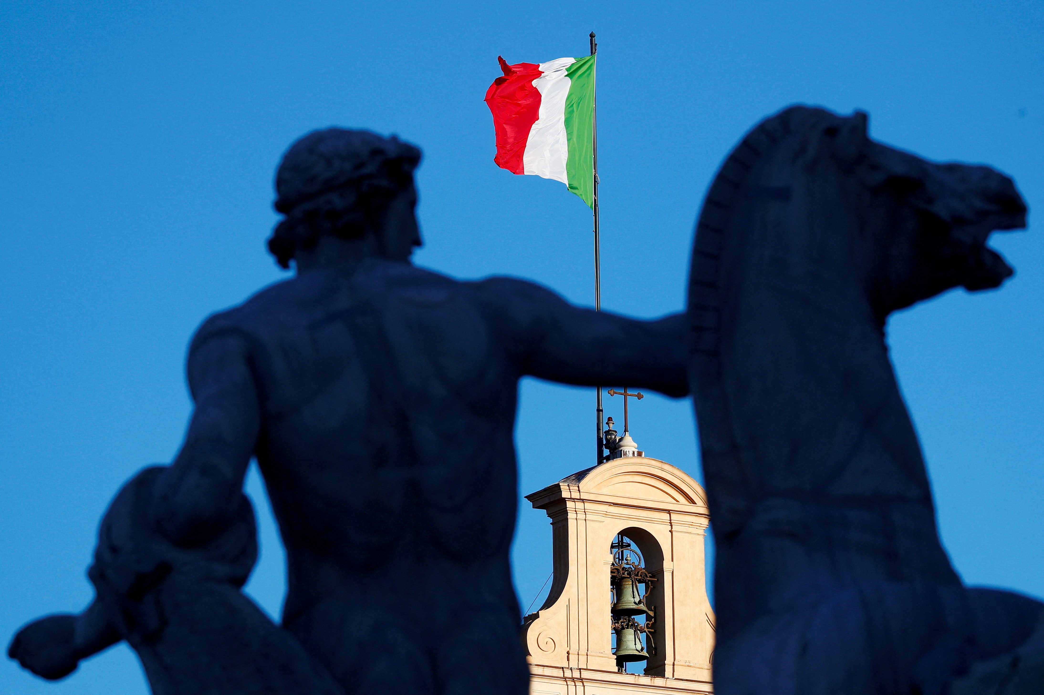 An Italian flag flies over the Quirinale Palace in Rome, Italy