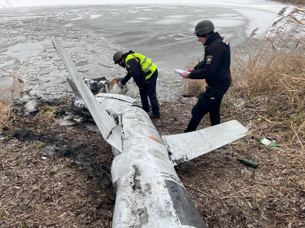 Police officers inspect a Russian cruise missile shot down by the Ukrainian Air Defence Forces in Kyiv region