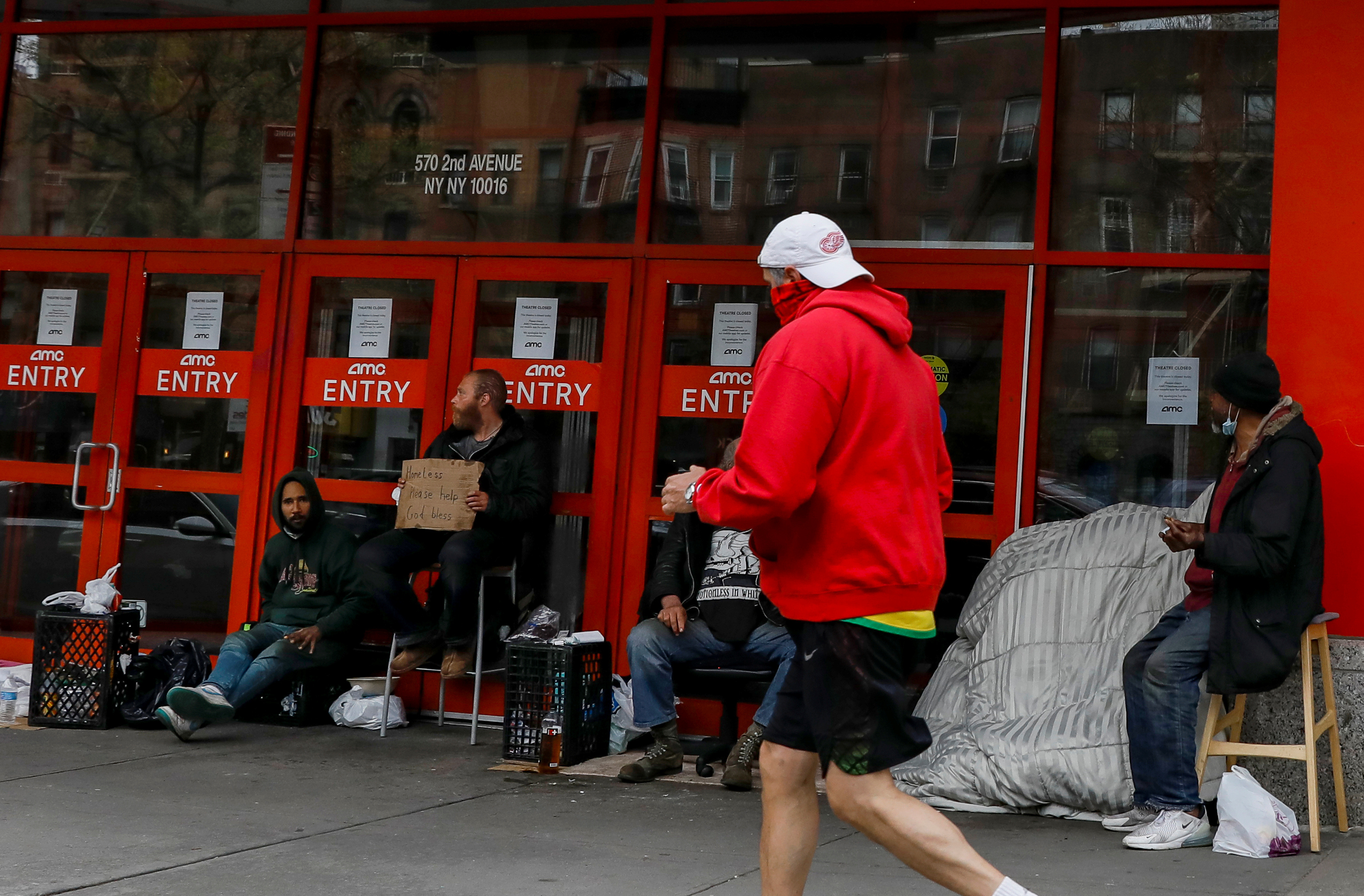 Homeless people gather outside a closed AMC Theatre during the outbreak of the coronavirus disease (COVID-19), in New York