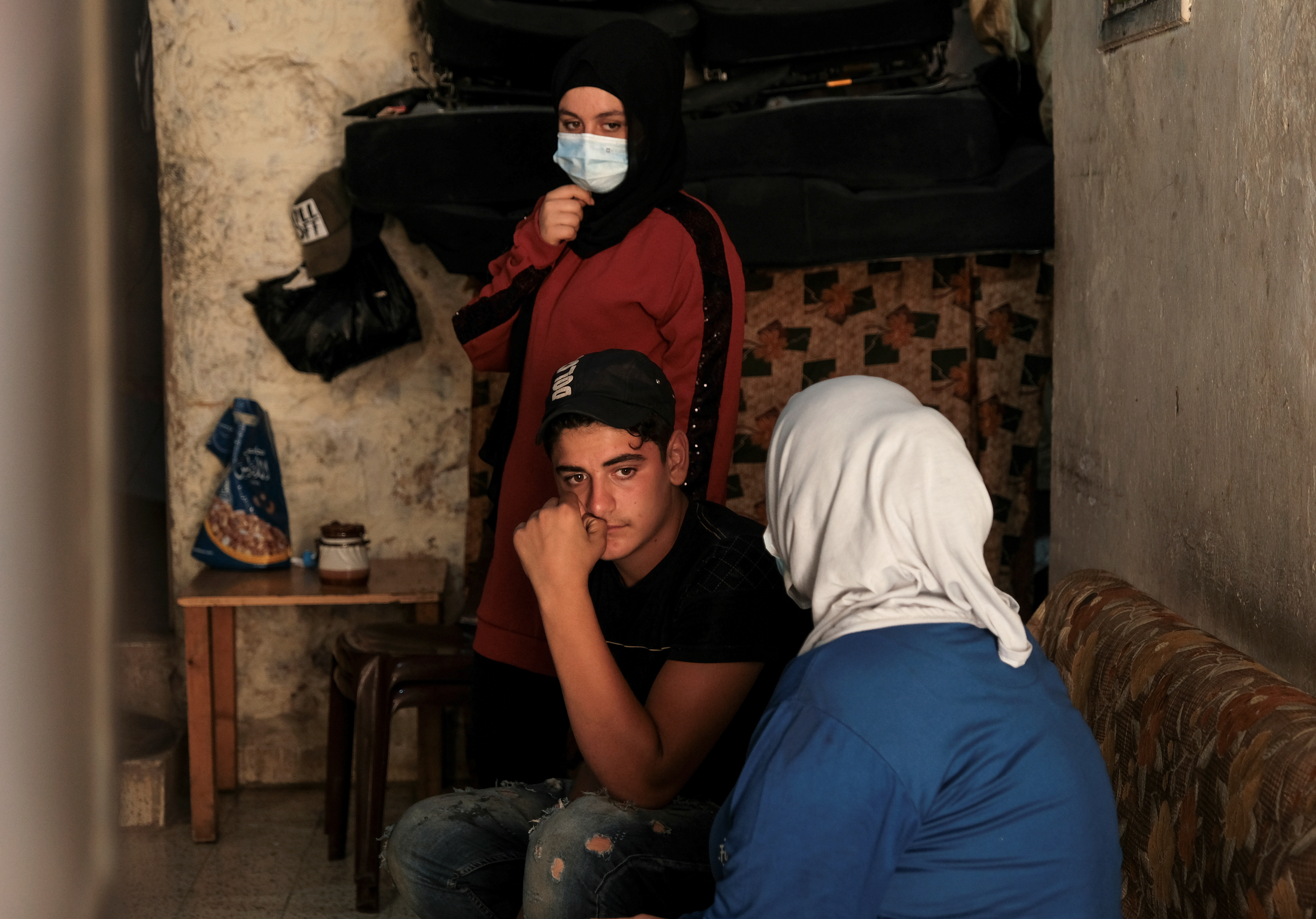 Shadi Lababidi, 16, sits with his mother and sister at their home in Tripoli