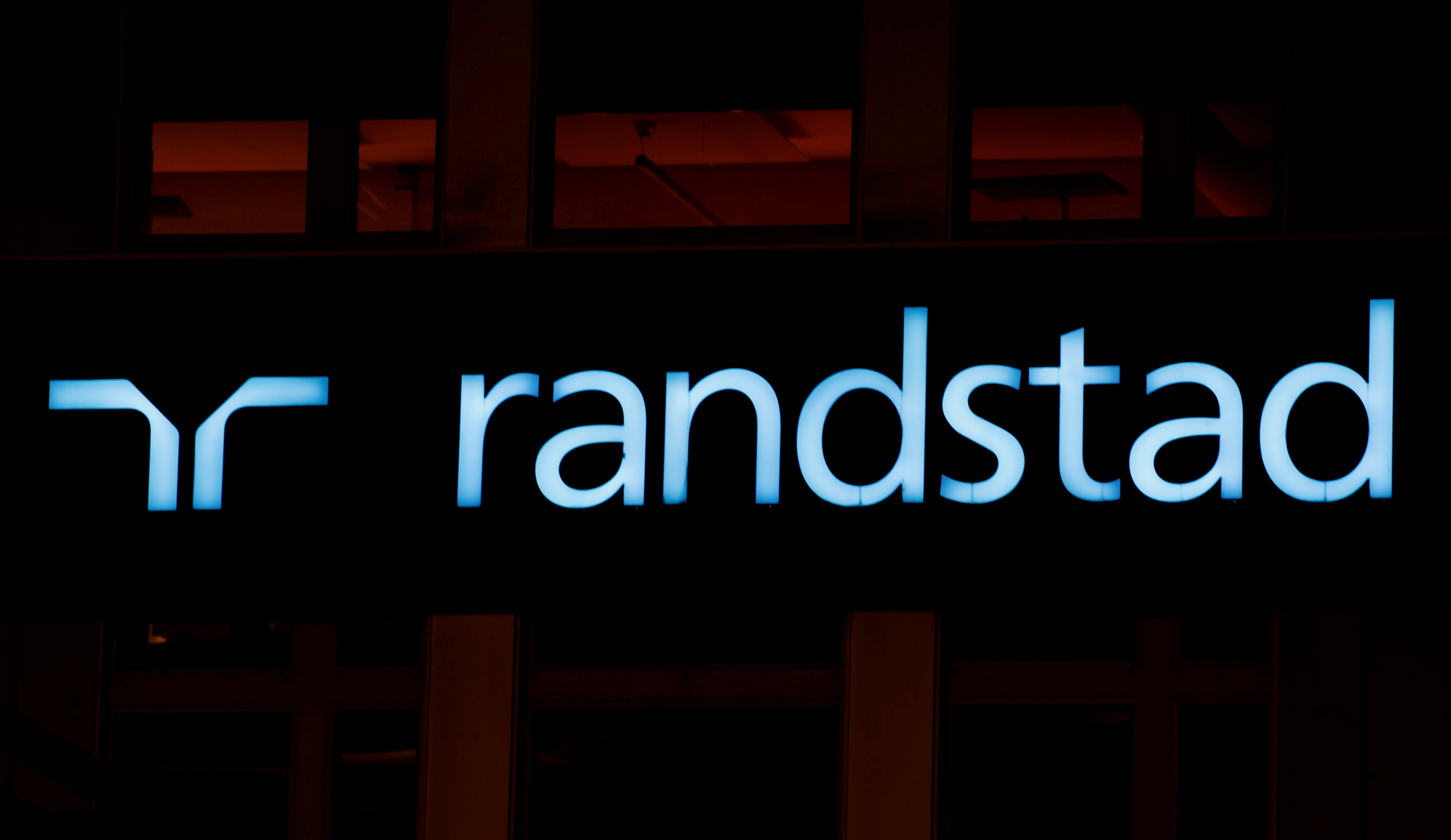 The logo of personnel service provider Randstad is seen at an office building in Zurich, Switzerland October 2, 2018.  REUTERS/Arnd Wiegmann/File Photo