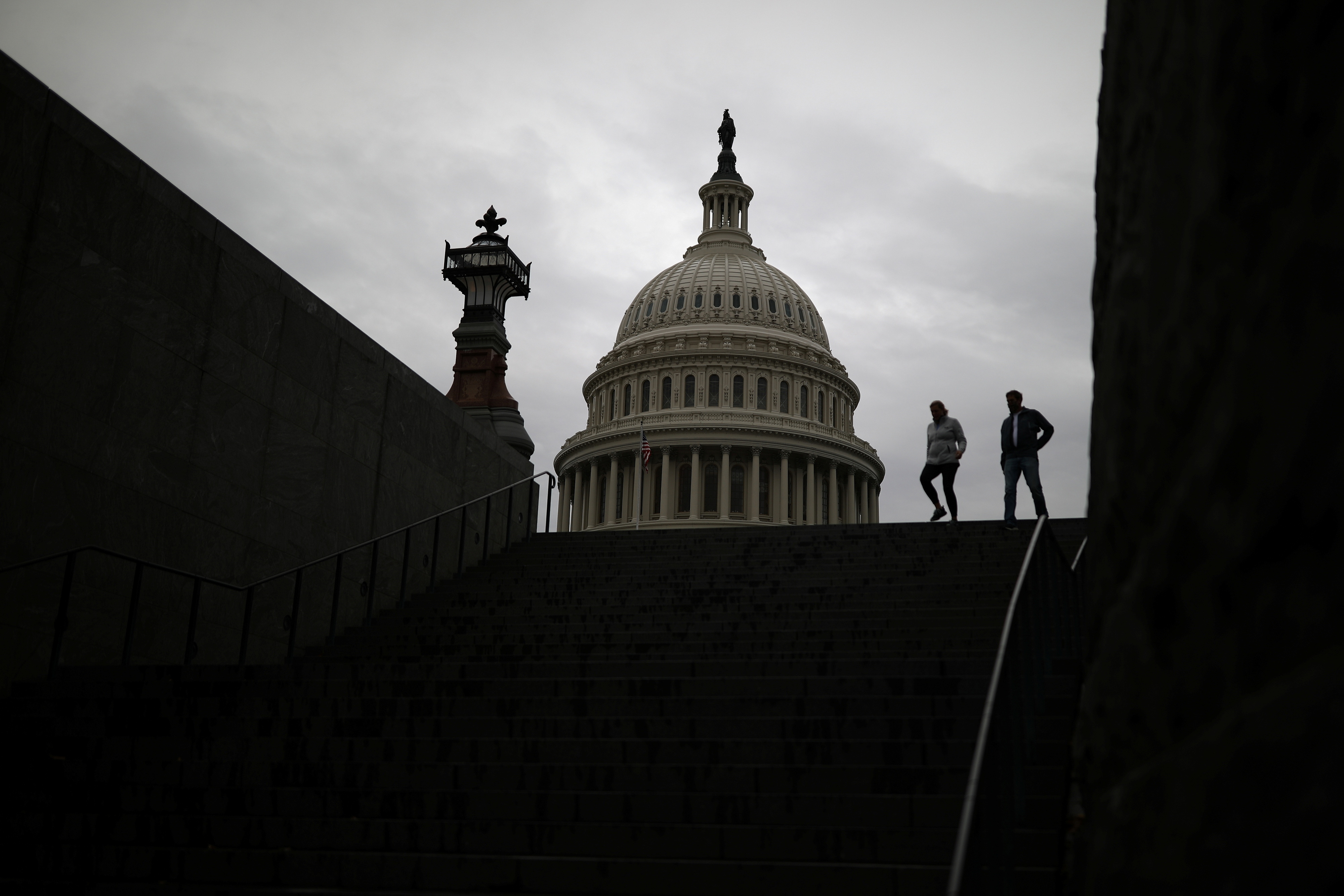 Pedestrians walk along the East Front of the U.S. Capitol Building on Capitol Hill in Washington