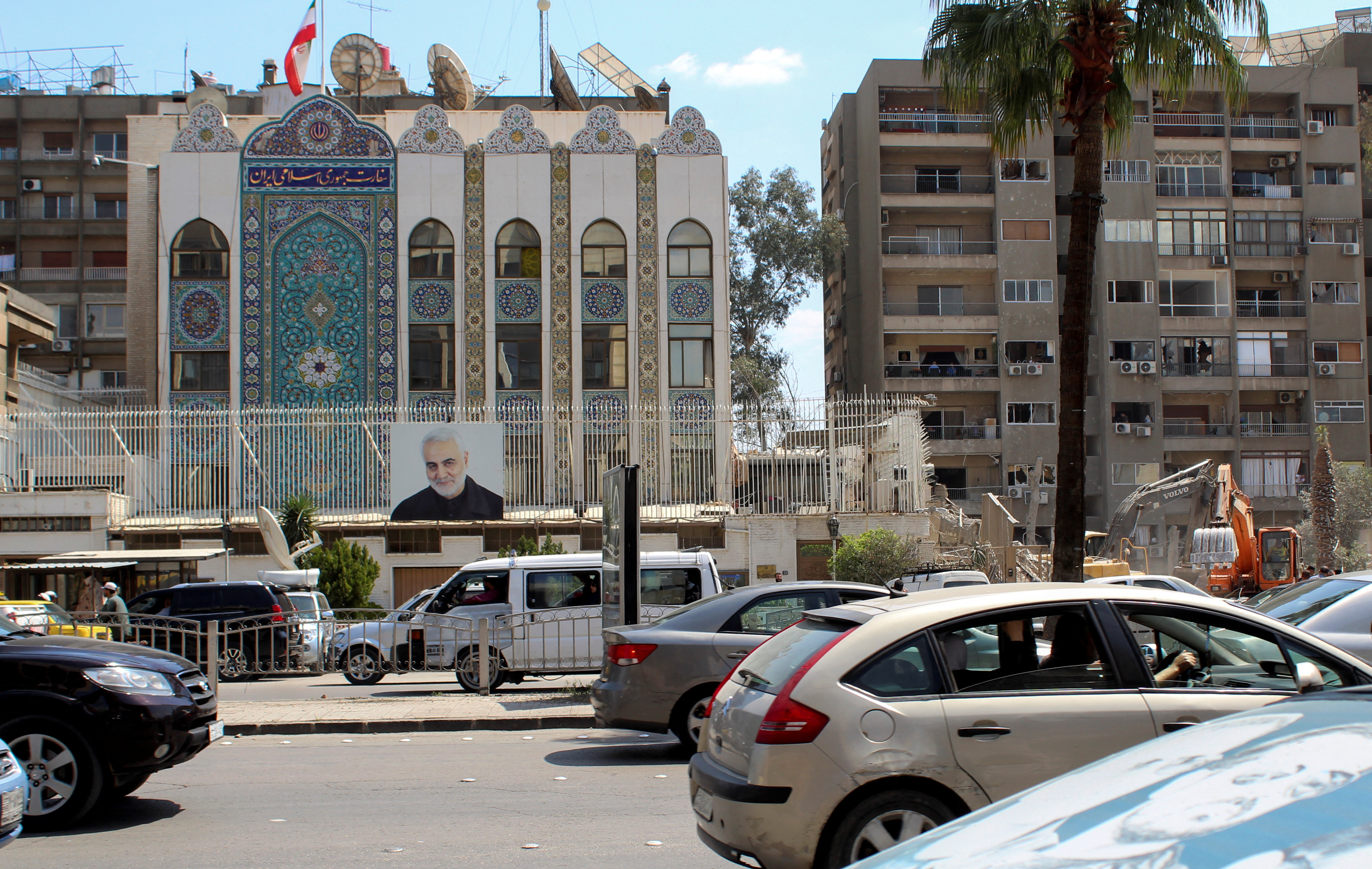 Vehicles drive near the Iranian embassy in Damascus