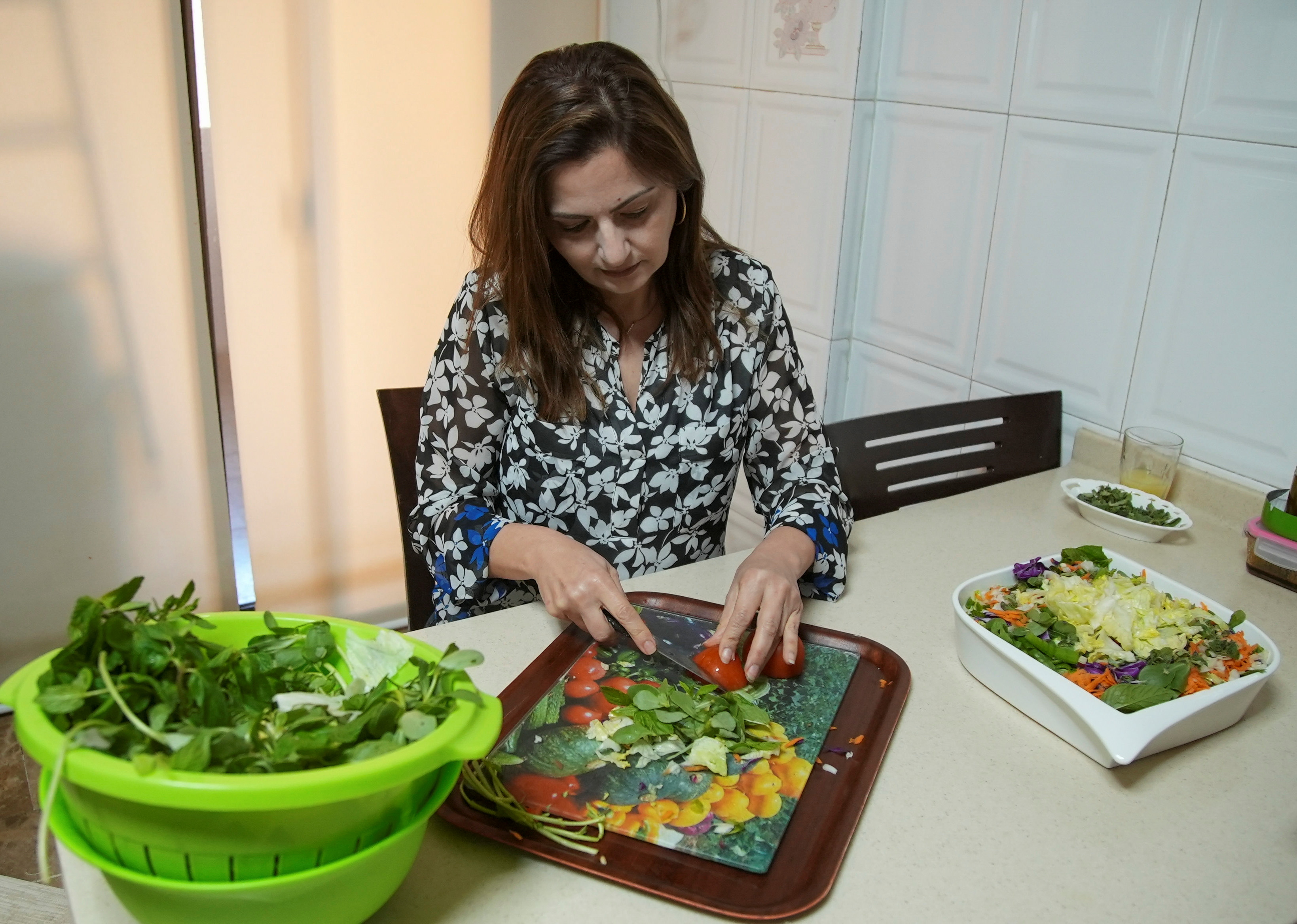 Hala Sheikh prepares Fattoush, a popular salad, at her house in Beirut