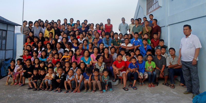 Family members of Ziona poses for group photograph outside their residence in village Baktawng