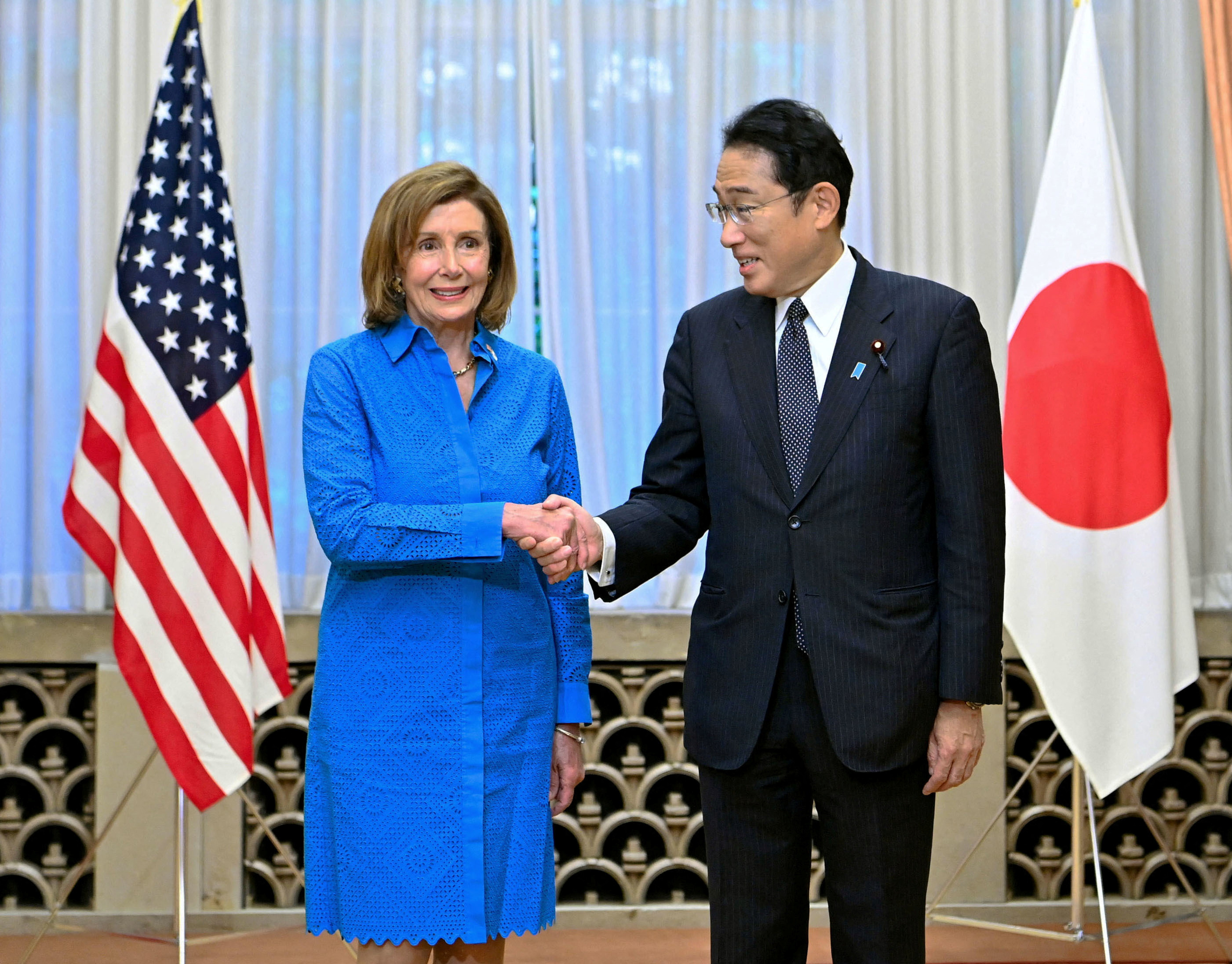 U.S. House of Representatives Speaker Nancy Pelosi shakes hands with Japan's Prime Minister Fumio Kishida before their breakfast meeting in Tokyo