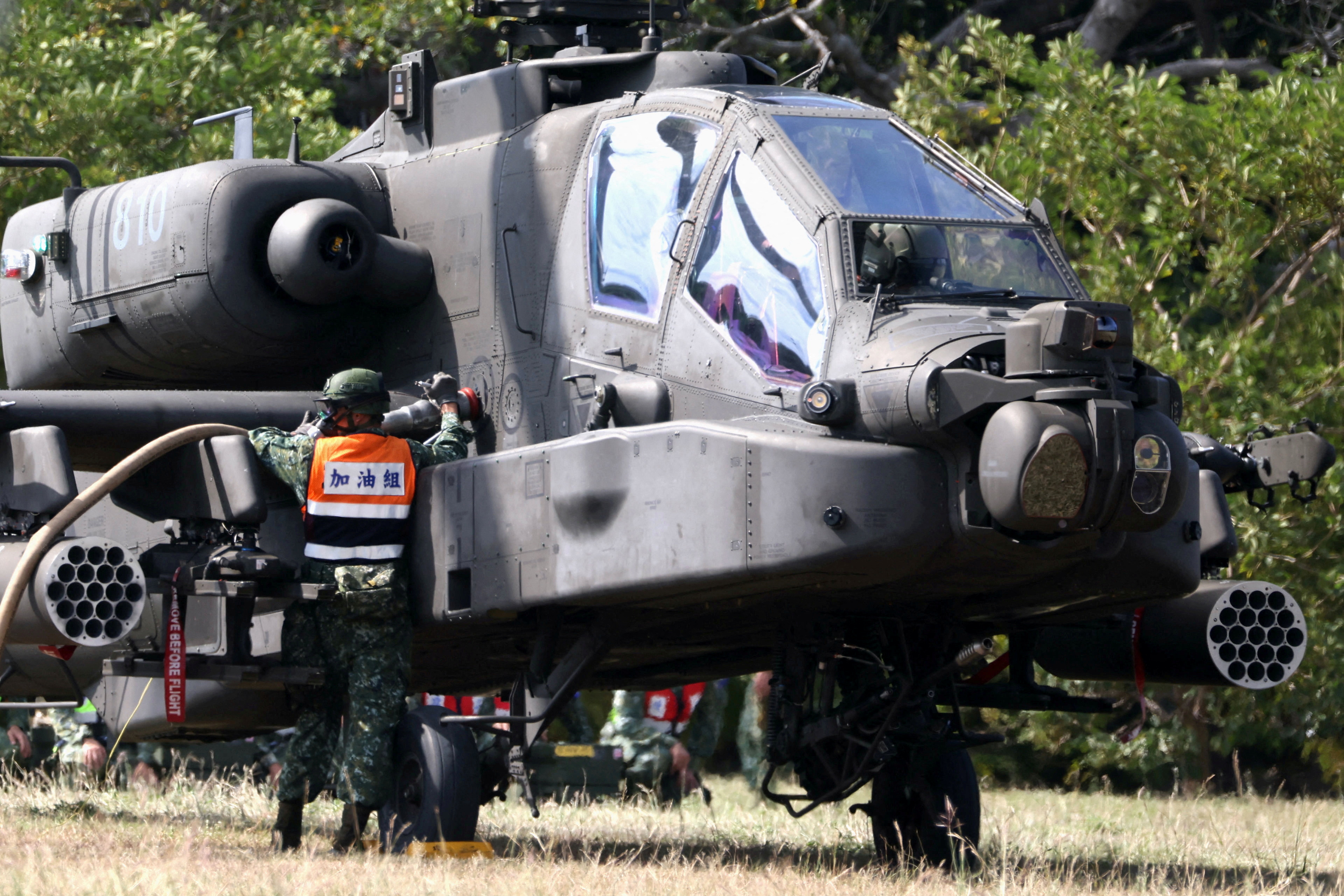 A soldier refuels an AH-64E Apache attack helicopter before take off during 'Combat Readiness Week' drills in Hsinchu