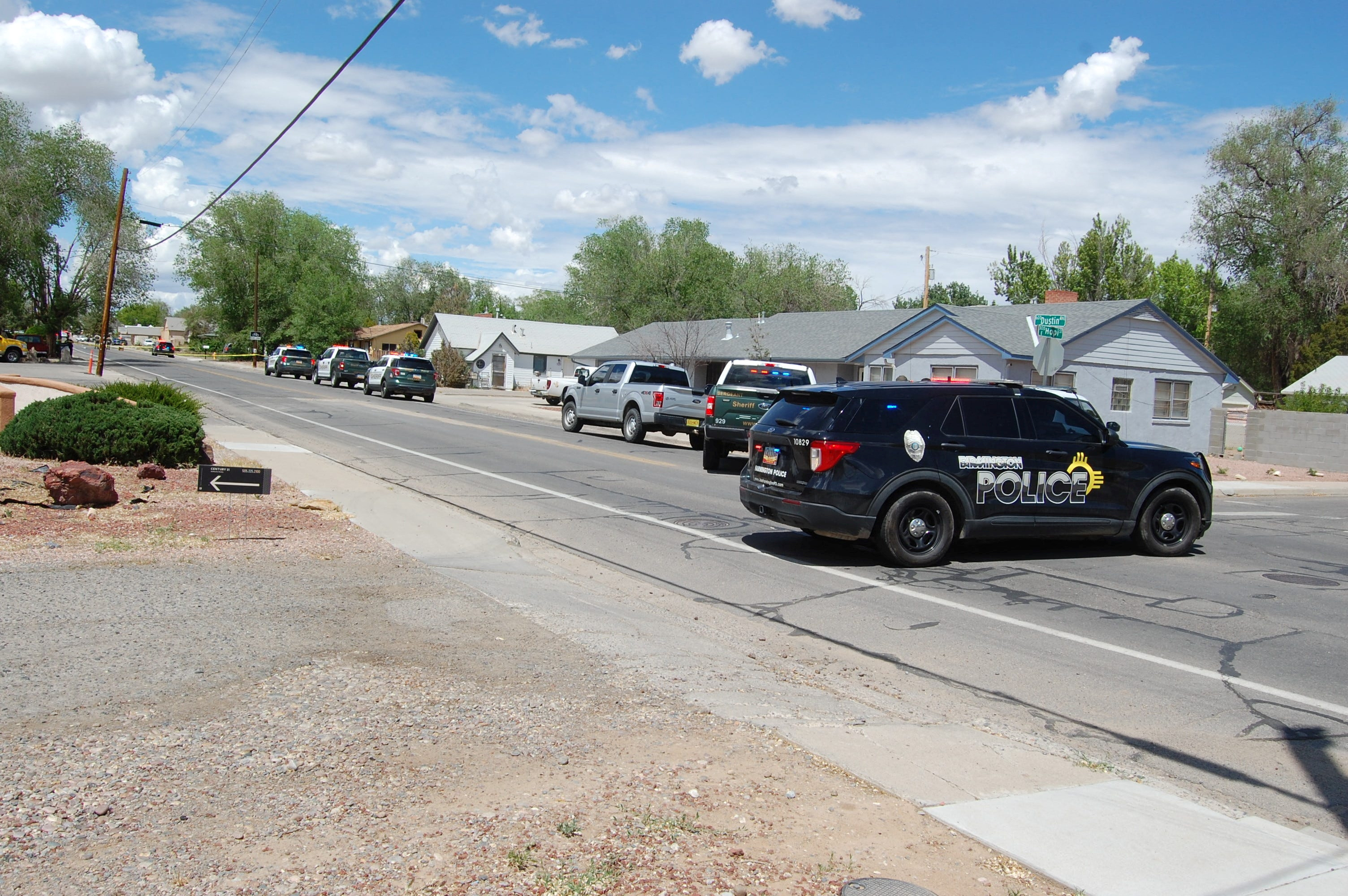 Law enforcement officers deploy at the scene of a fatal shooting in Farmington