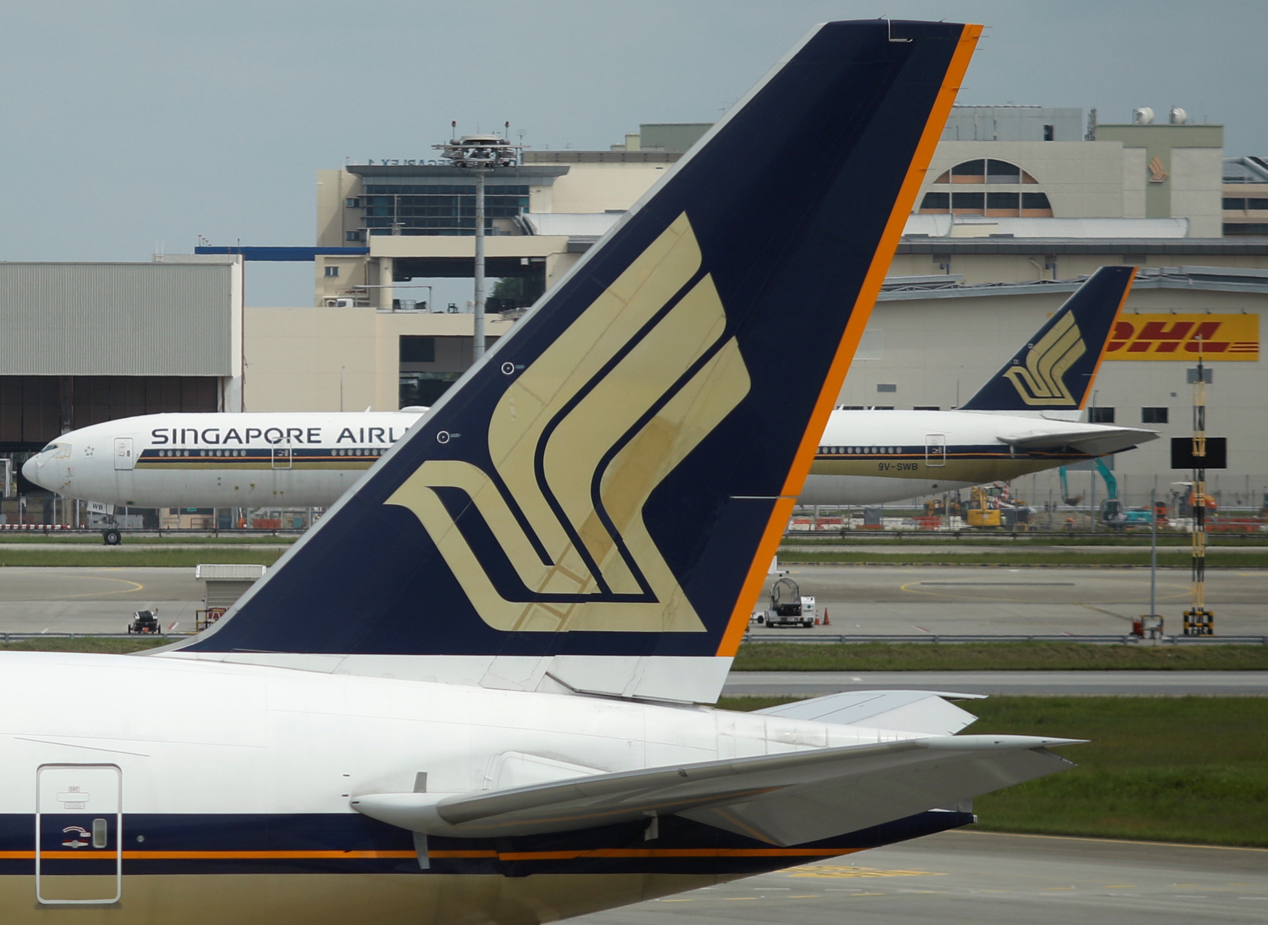 Singapore Airlines planes sit on the tarmac at Changi Airport in Singapore
