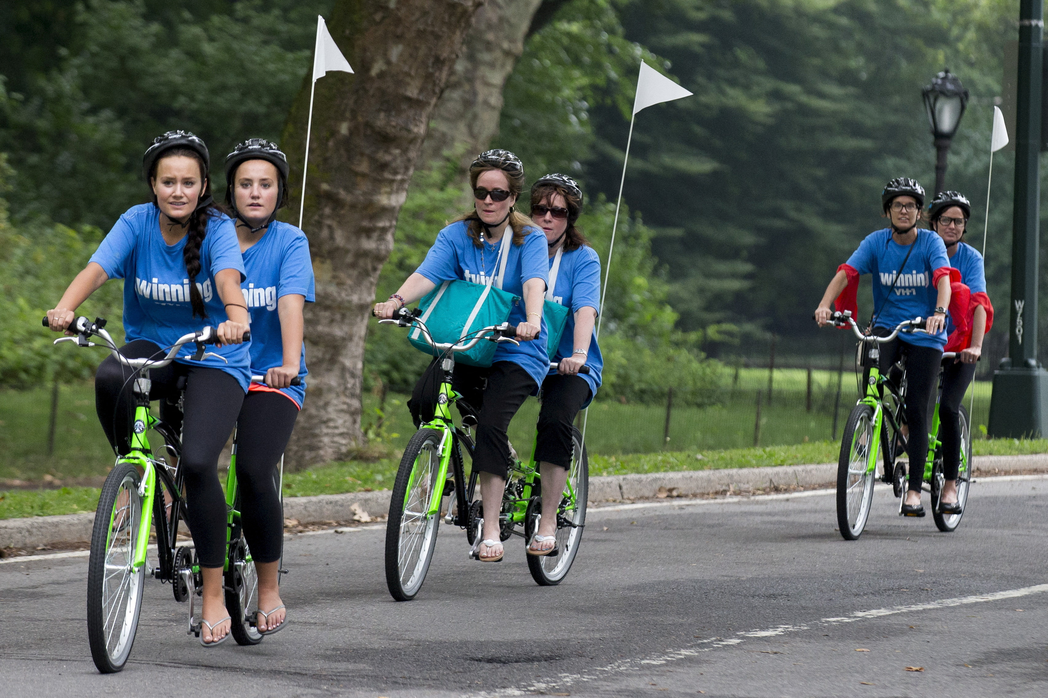 Sets of twins ride on tandem bicycles in New York's Central Park