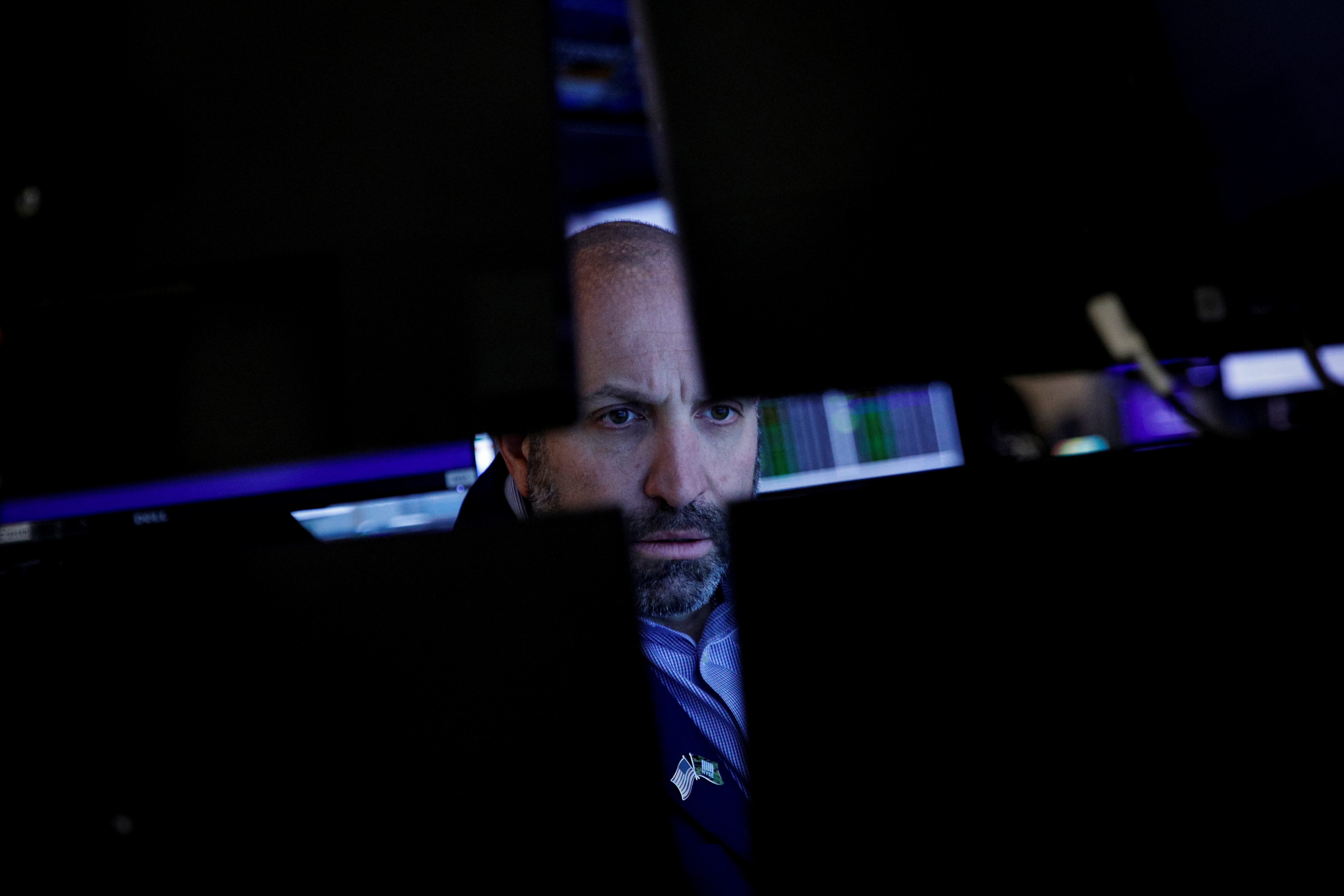 A specialist trader works inside a post  on the floor of the NYSE in New York