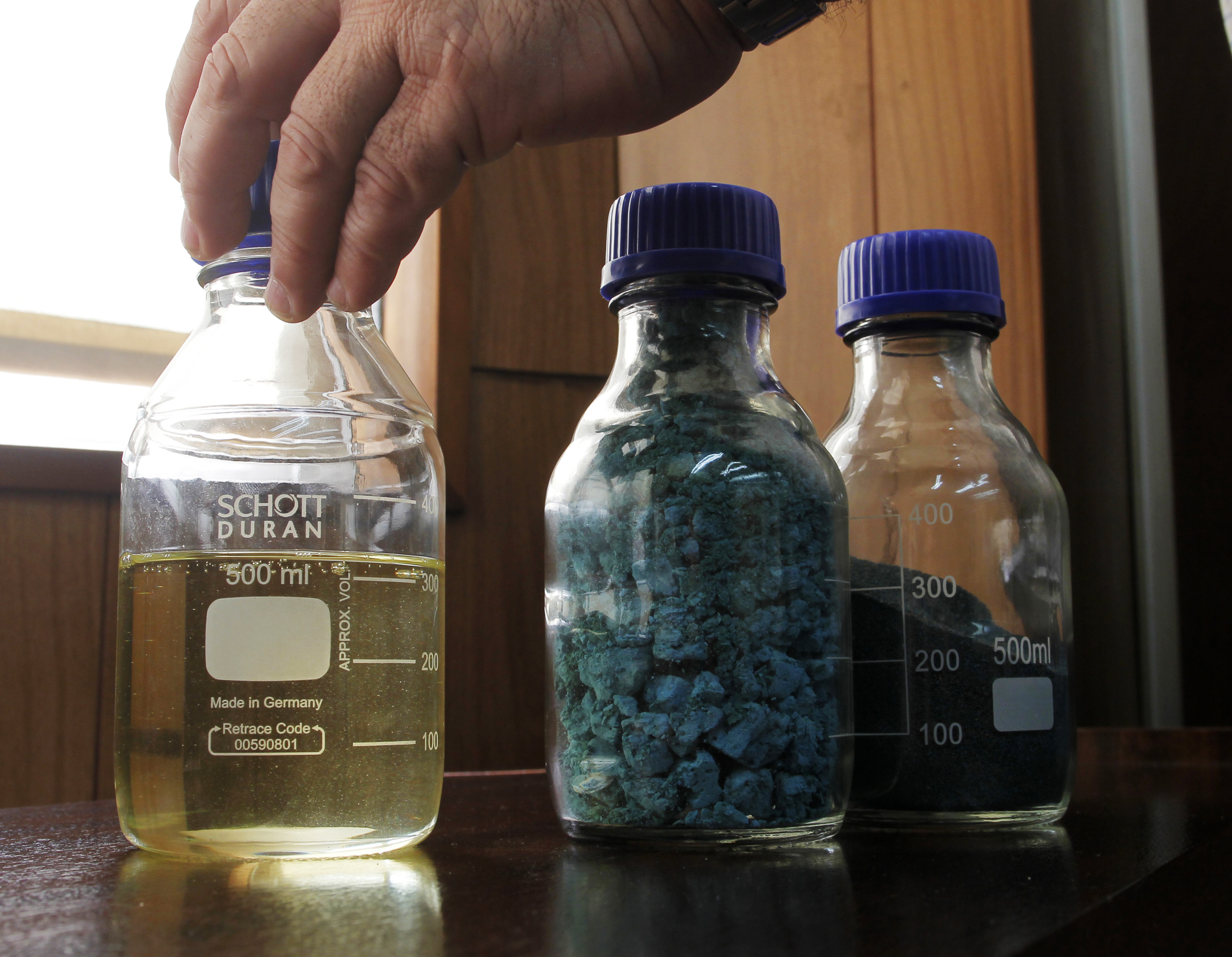 A sample of biodiesel made from algae and samples of algae are displayed at a newly opened biofuel factory in San Nicolas