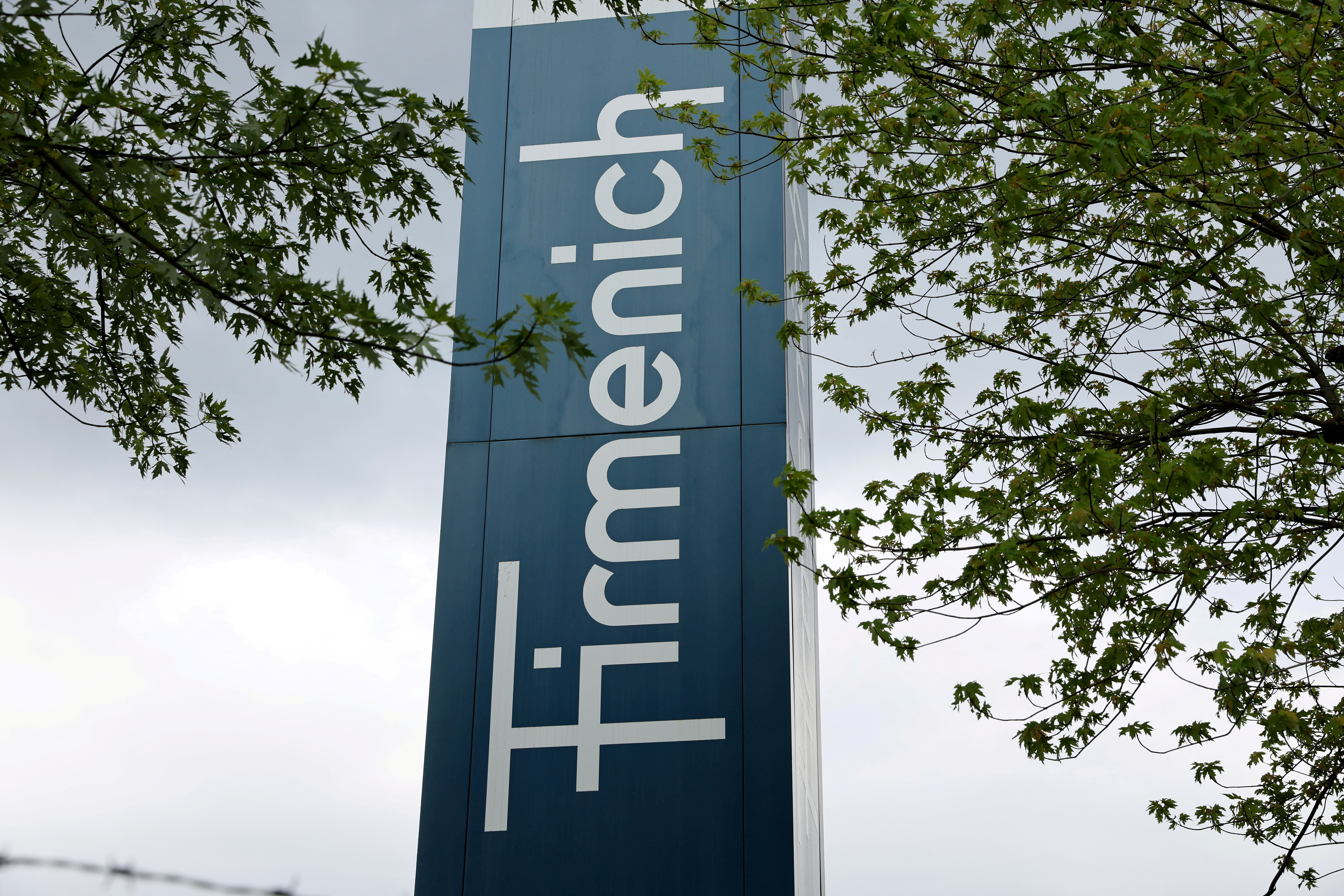 A logo is pictured in front of flavour and fragrance maker Firmenich production site, in Meyrin