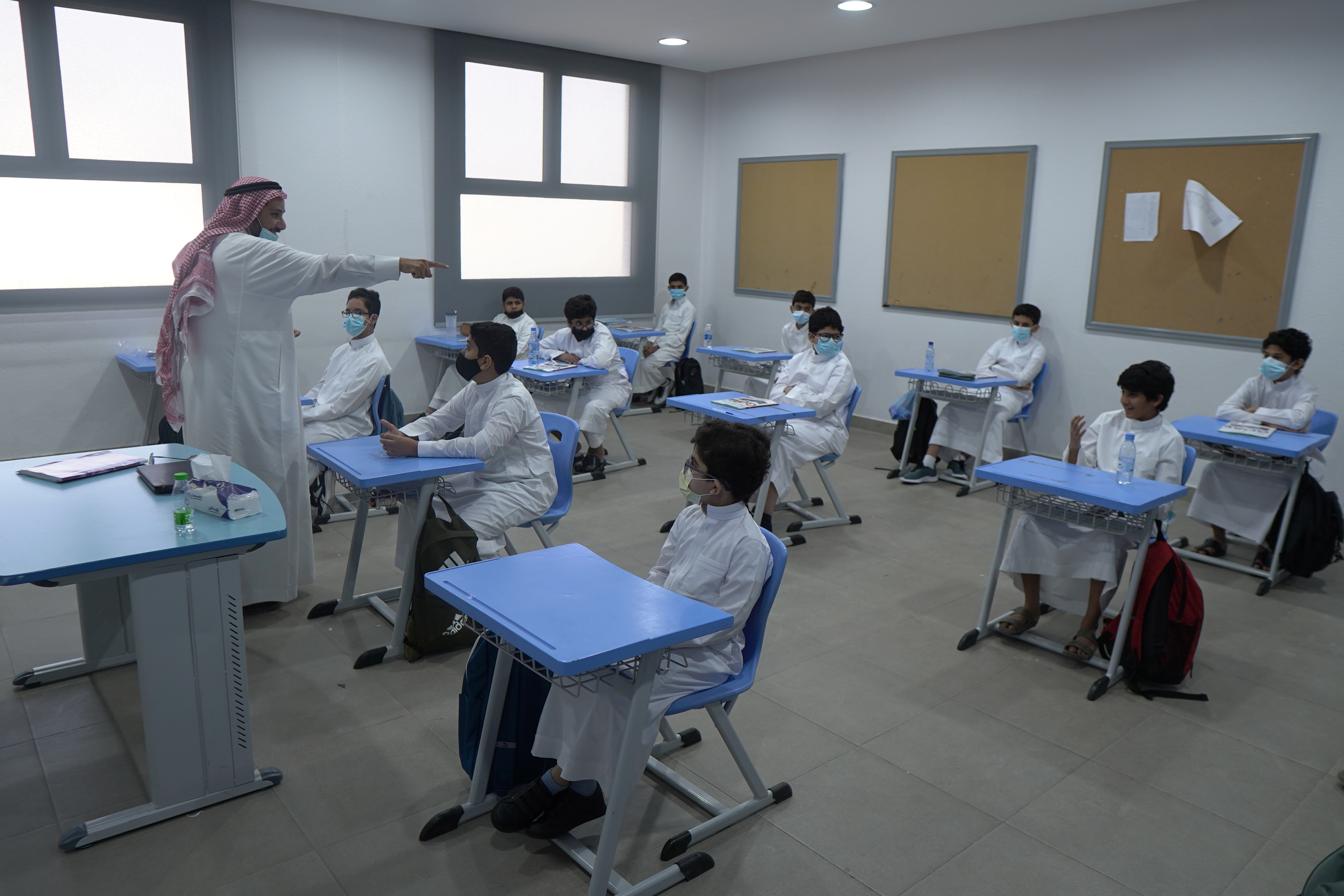 Saudi students return to school with masks and checks | Reuters