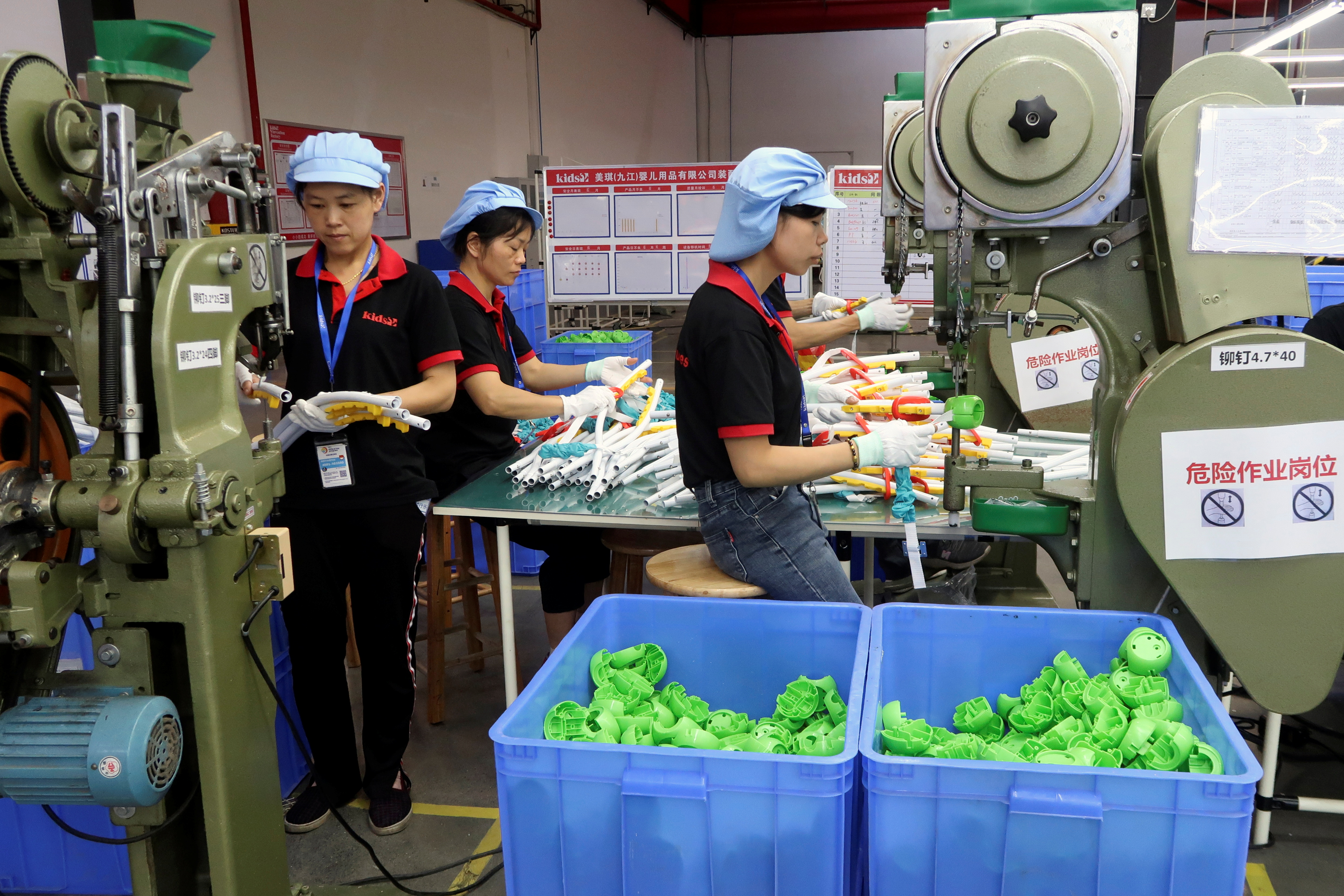 Employees work on the production line of Kids II Inc at a factory in Jiujiang