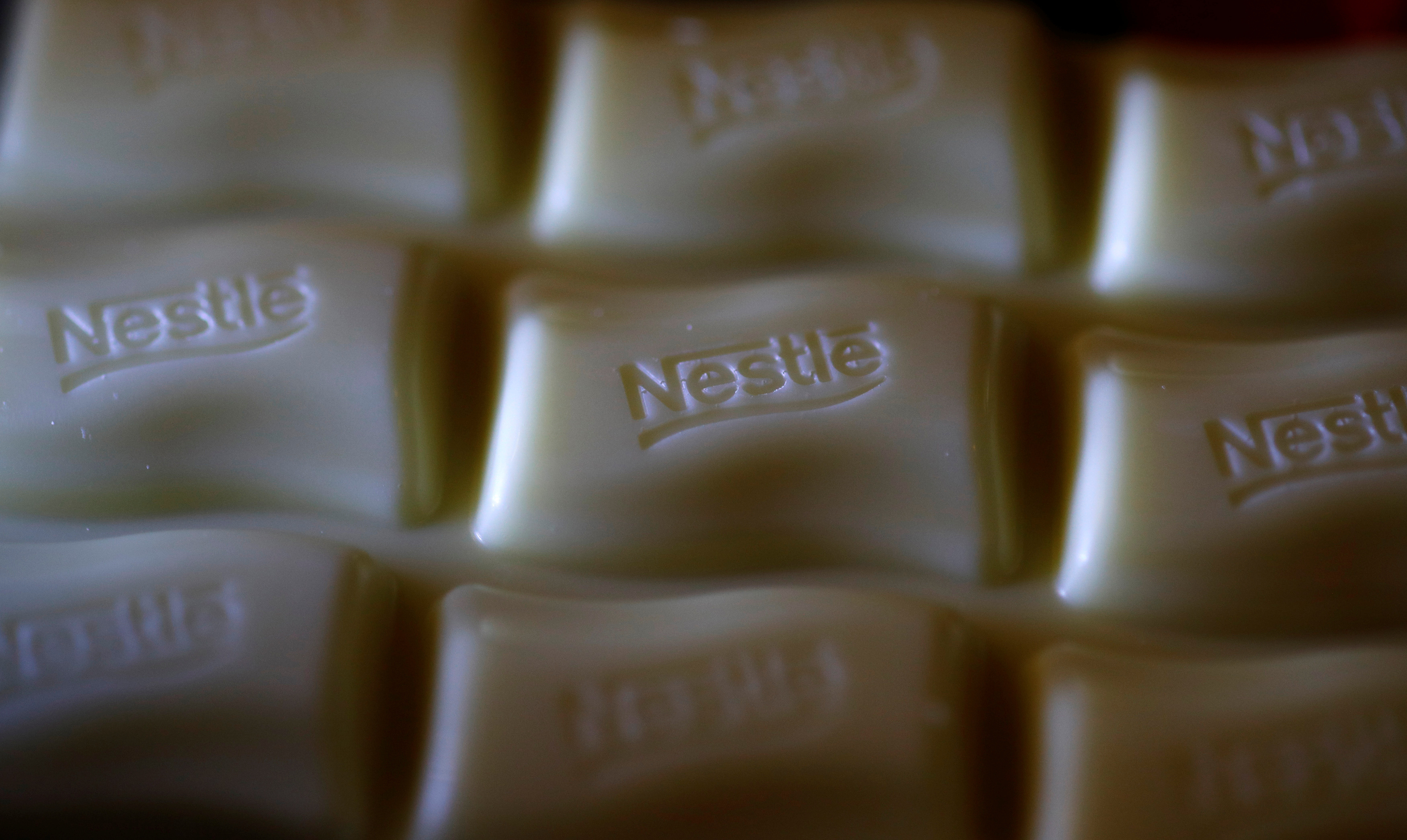 A Nestle company logo is pictured on a bar of Milky Bar chocolate in Manchester, Britain.