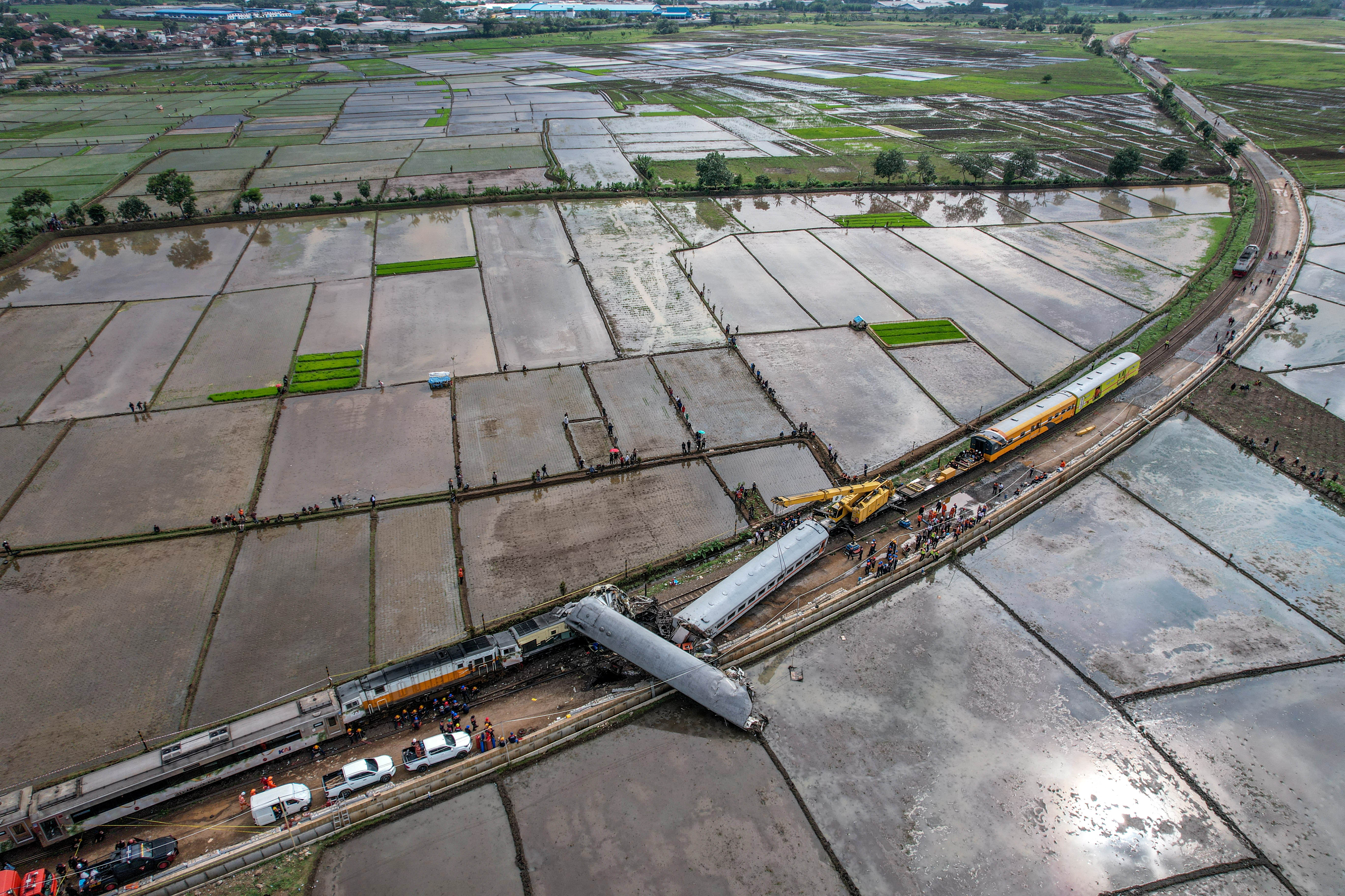 An aerial view shows a crane operating to clear the wreckage after a train collision between the local Bandung Raya train and the Turangga train in Cicalengka