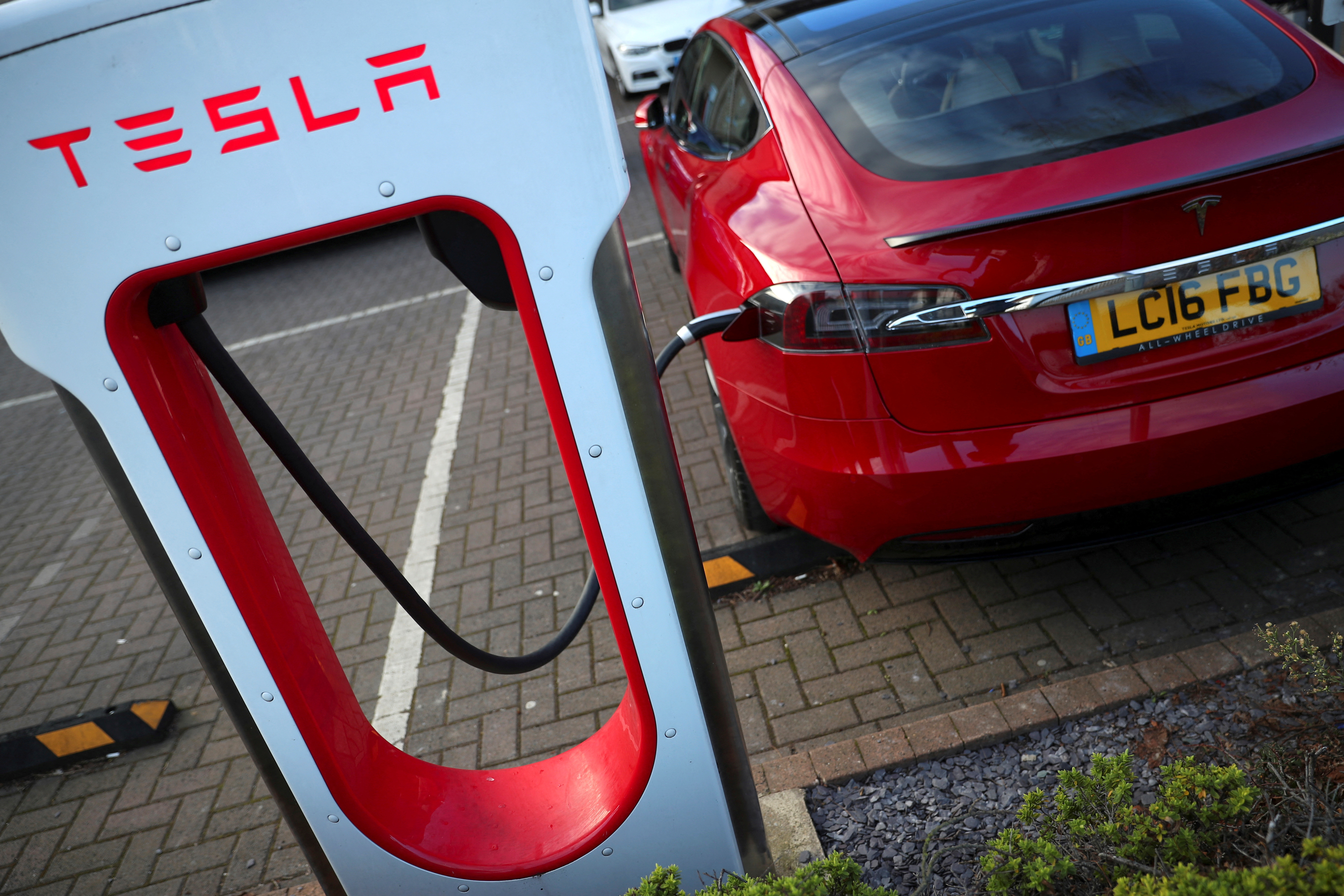 A Tesla car is charged at a Tesla dealership in West Drayton, just outside London