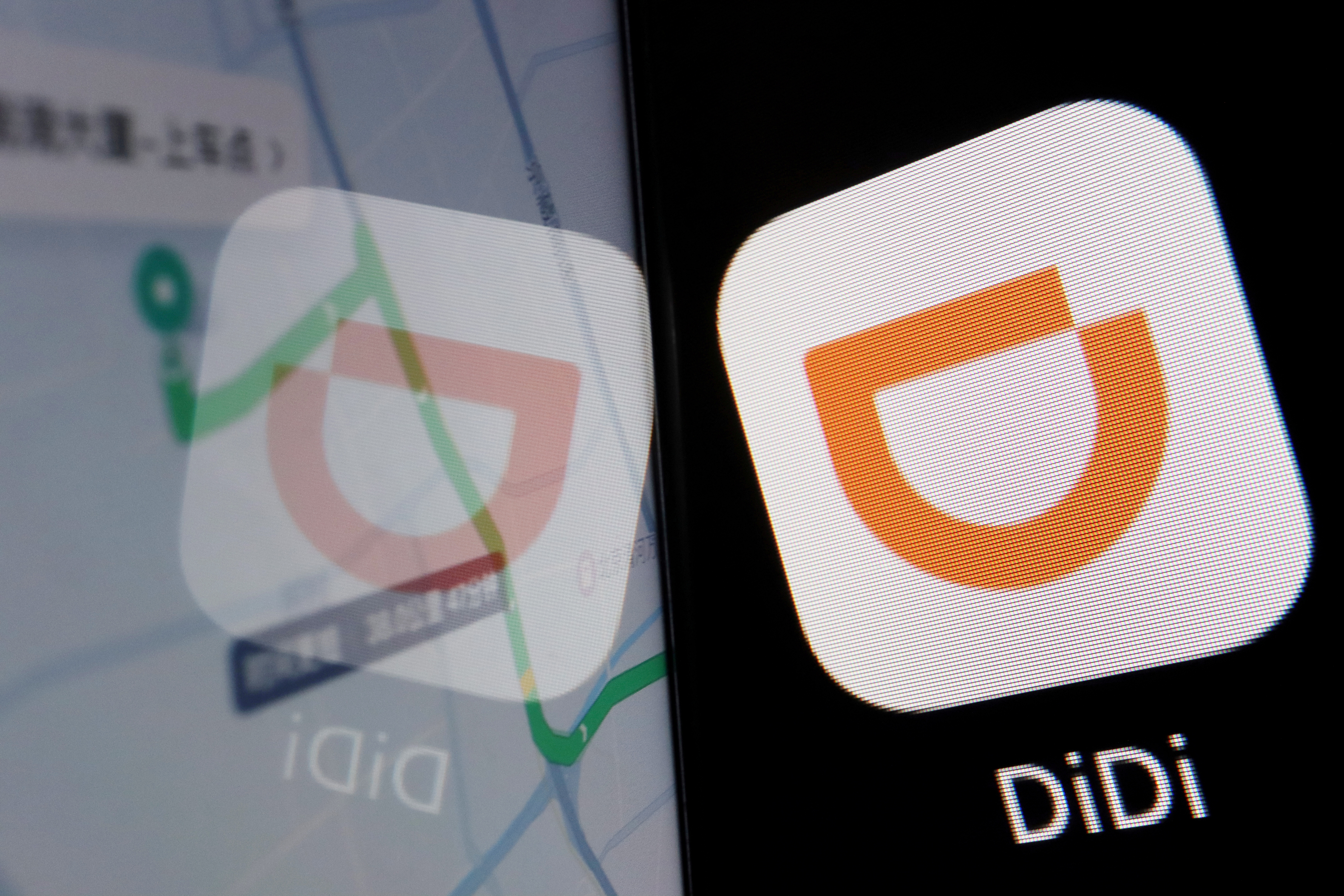 The app logo of Chinese ride-hailing giant Didi is seen reflected on its navigation map displayed on a mobile phone in this illustration picture taken July 1, 2021. REUTERS/Florence Lo/Illustration/File Photo