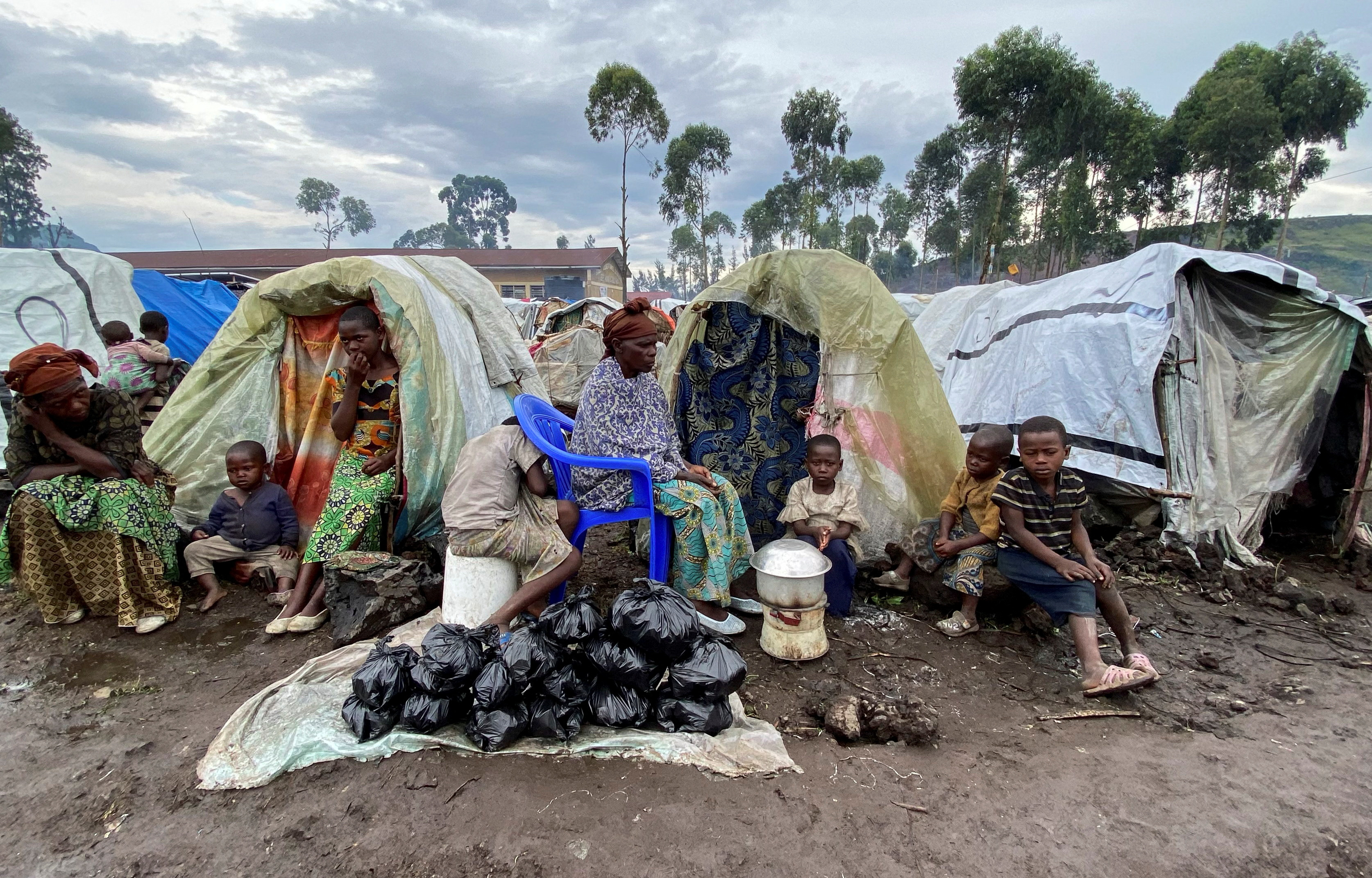 Paskazia Kimanuka sits with her children at the Kanyaruchinya camp for the internally displaced people near Goma