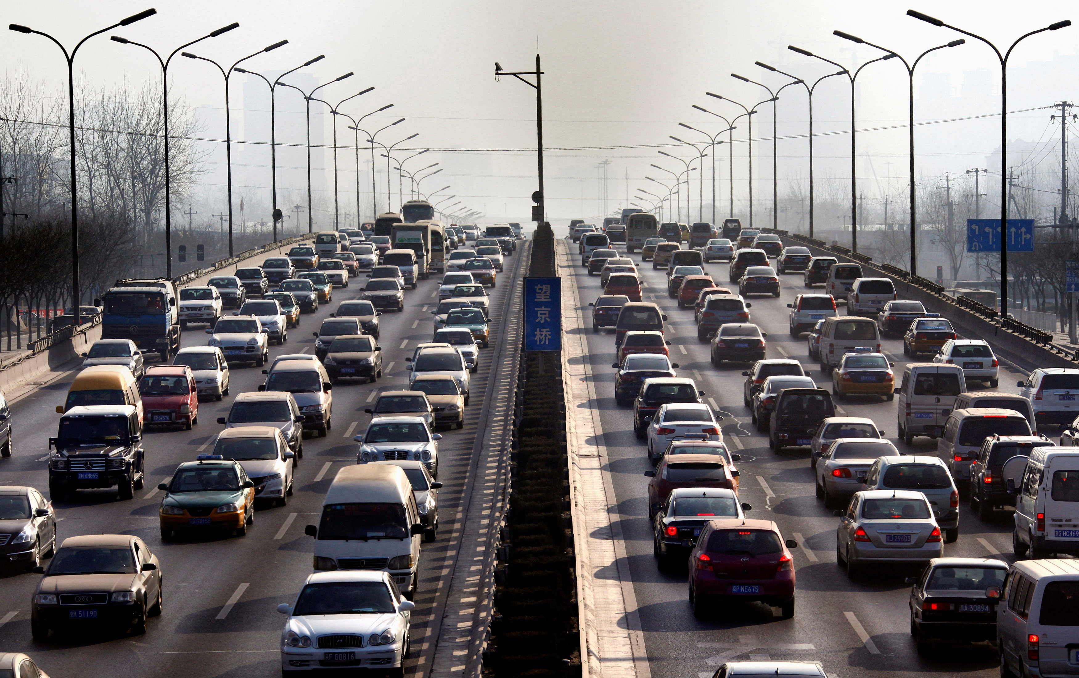 Cars drive along a main road in central Beijing