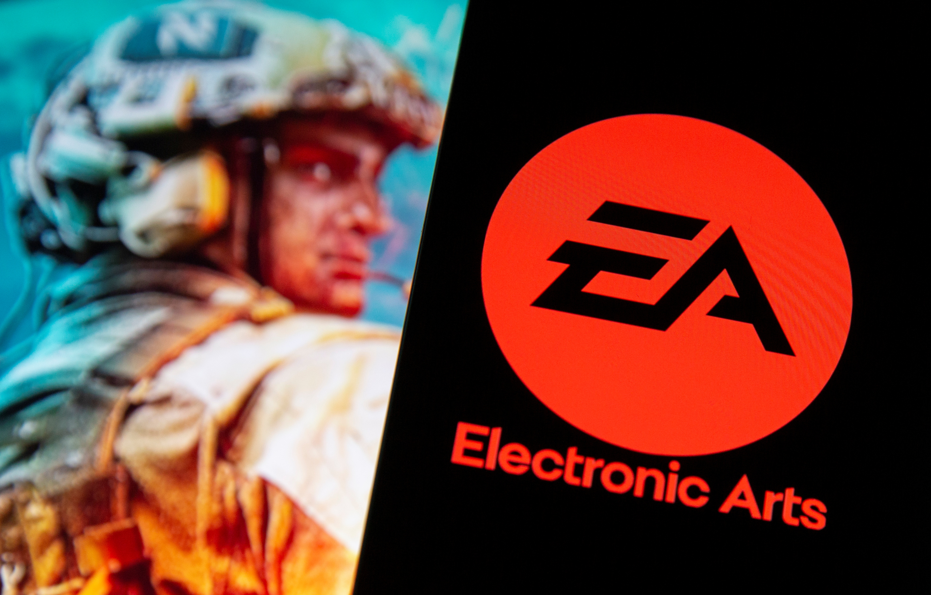 A smartphone with the Electronic Arts logo is seen in front of a displayed character from the Battlefield 2042 game in this illustration