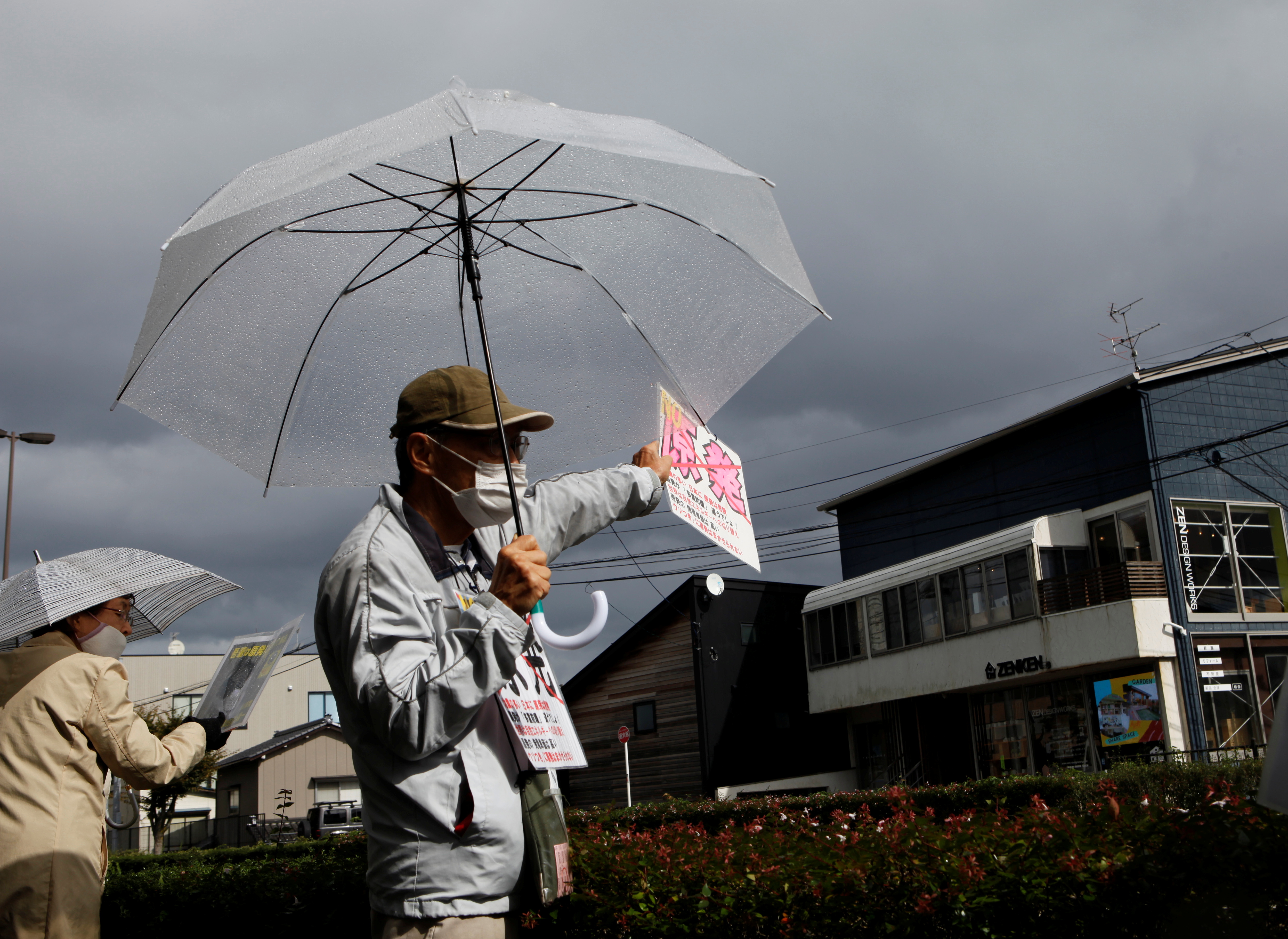 An anti-nuclear activist demonstrates in front of the Tokyo Electric Power Company Holdings office in Niigata, Niigata Prefecture, Japan, October 21, 2021. REUTERS/Sakura Murakami