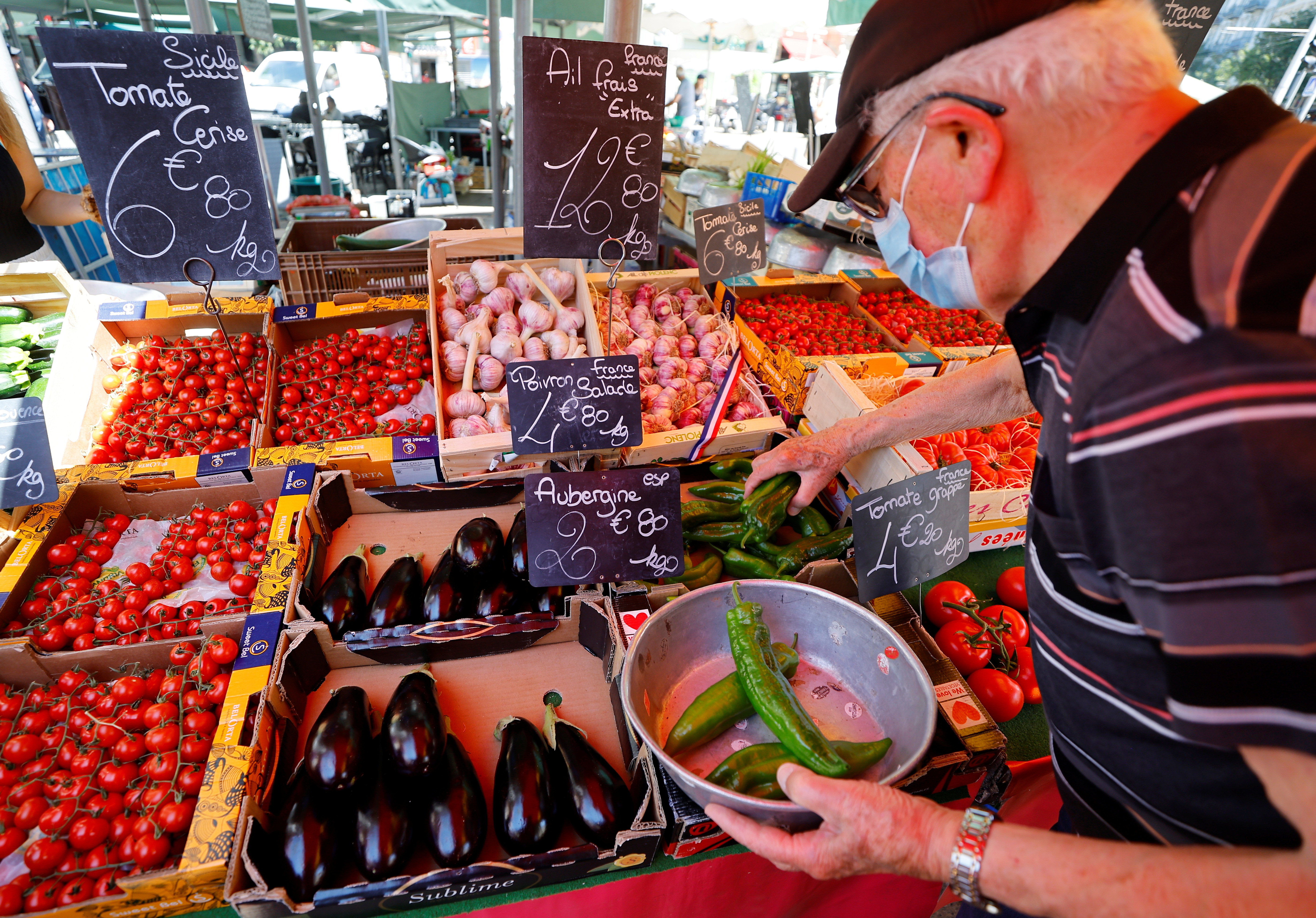 A man wearing a protective face mask shops at a local market in Nice