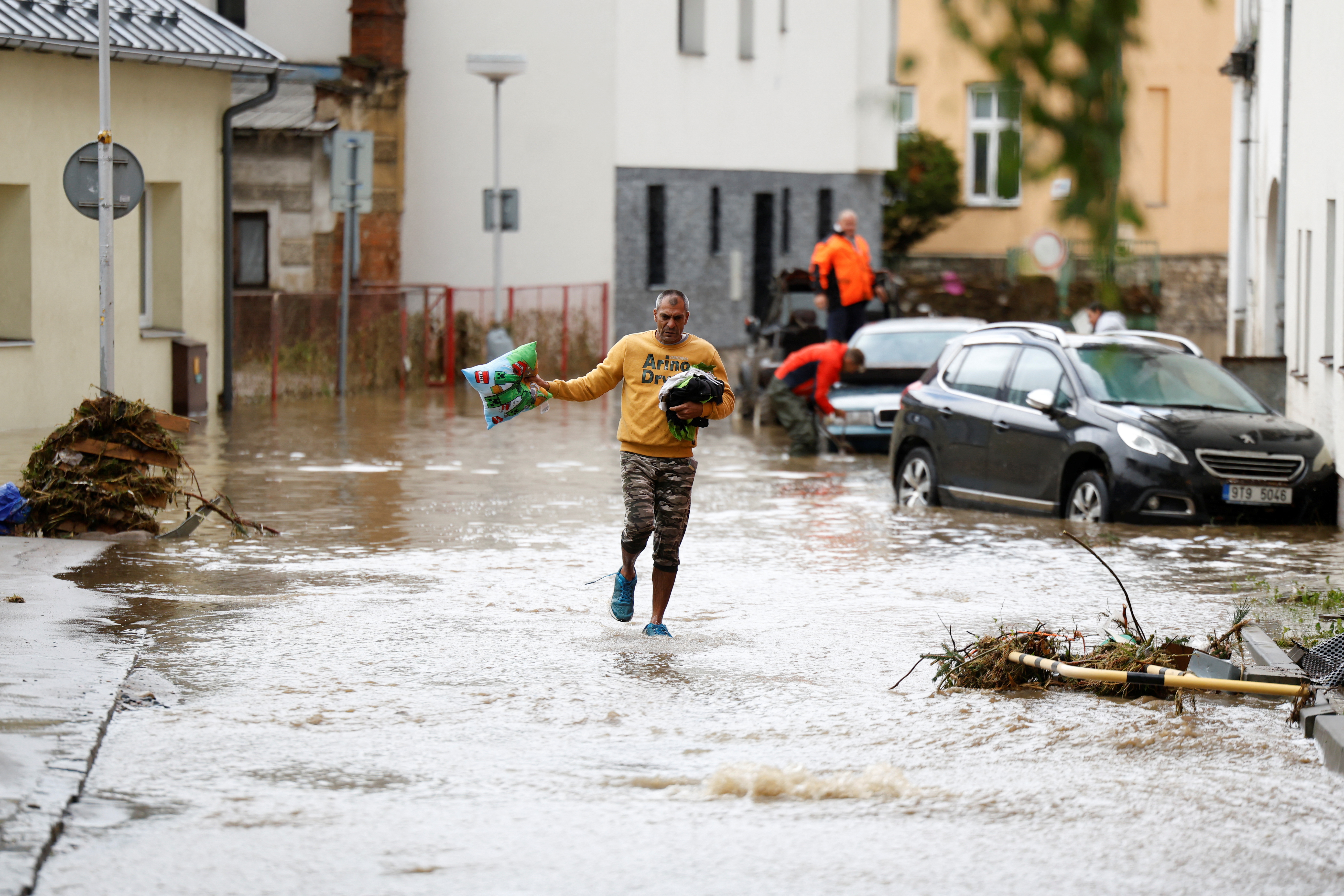 A man wades through floodwater at a flooded area, following heavy rainfall in Jesenik, Czech Republic, September 15, 2024. REUTERS/David W Cerny