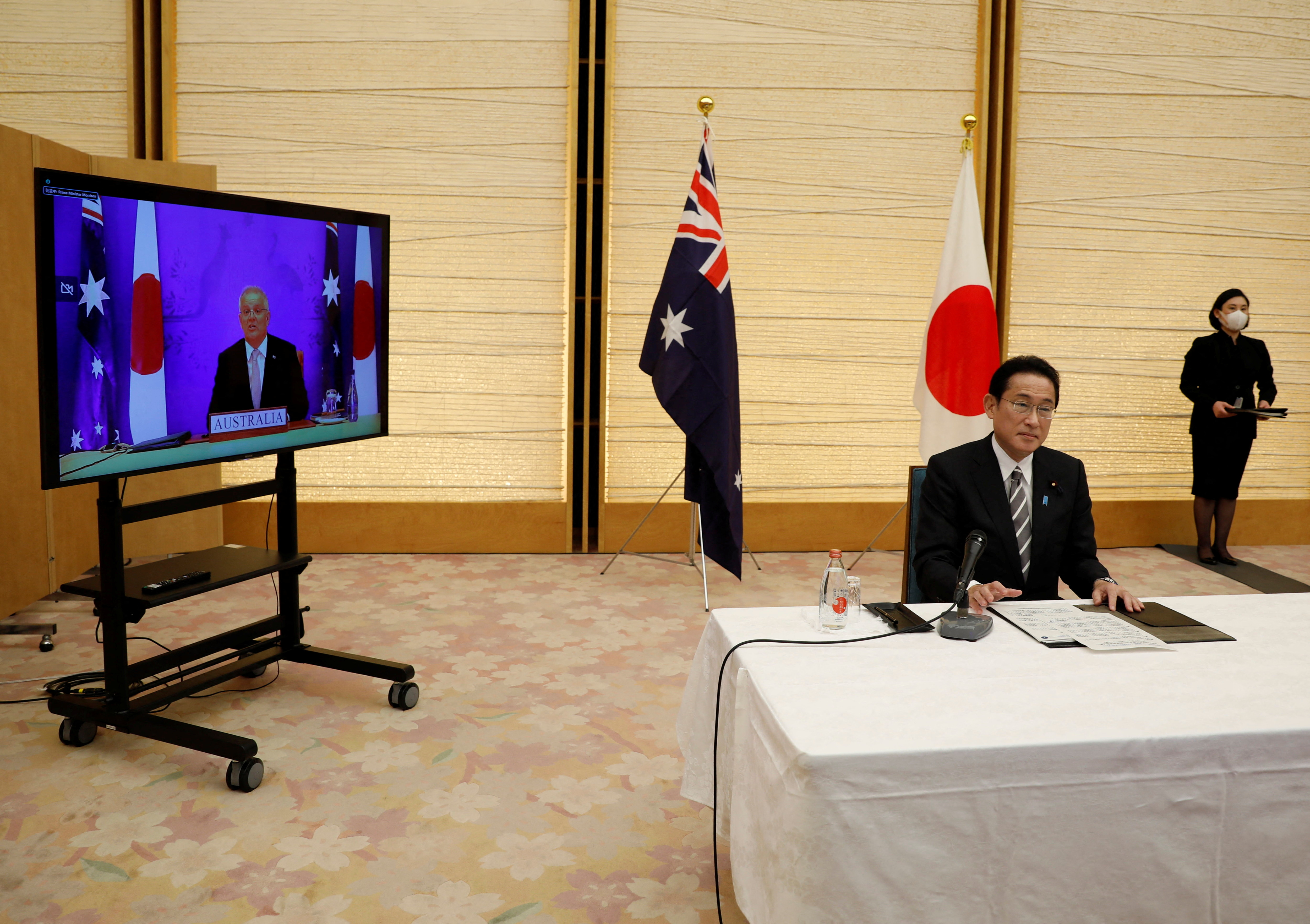 Japan's Prime Minister Fumio Kishida and Australia's Prime Minister Scott Morrison attend a video signing ceremony of the bilateral reciprocal access agreement in Tokyo