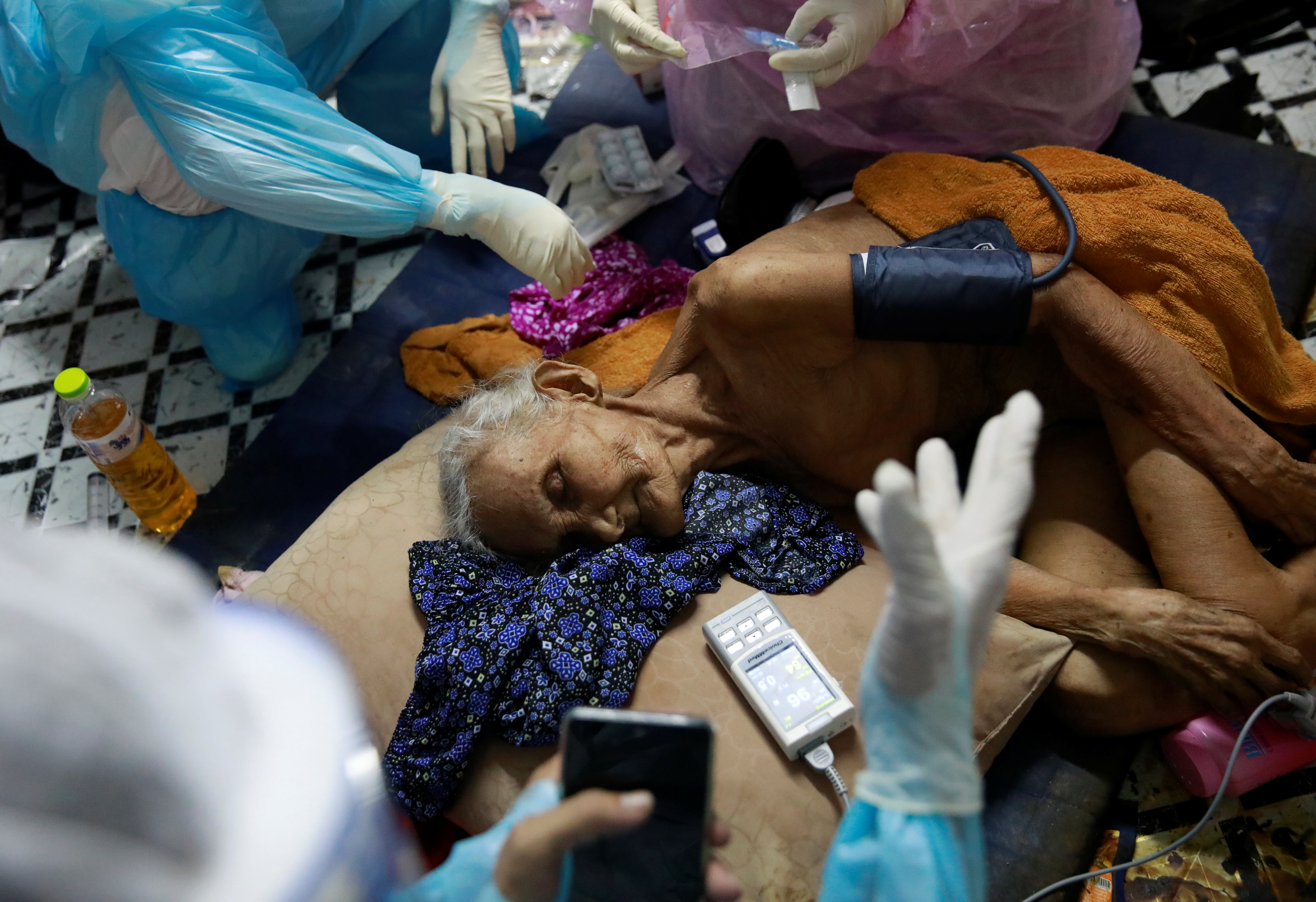 A 93-year-old coronavirus disease (COVID-19) patient Nuan, who lives without family, is treated by volunteers in Bangkok, Thailand August 5, 2021. Picture taken on August 5, 2021. REUTERS/Soe Zeya Tu