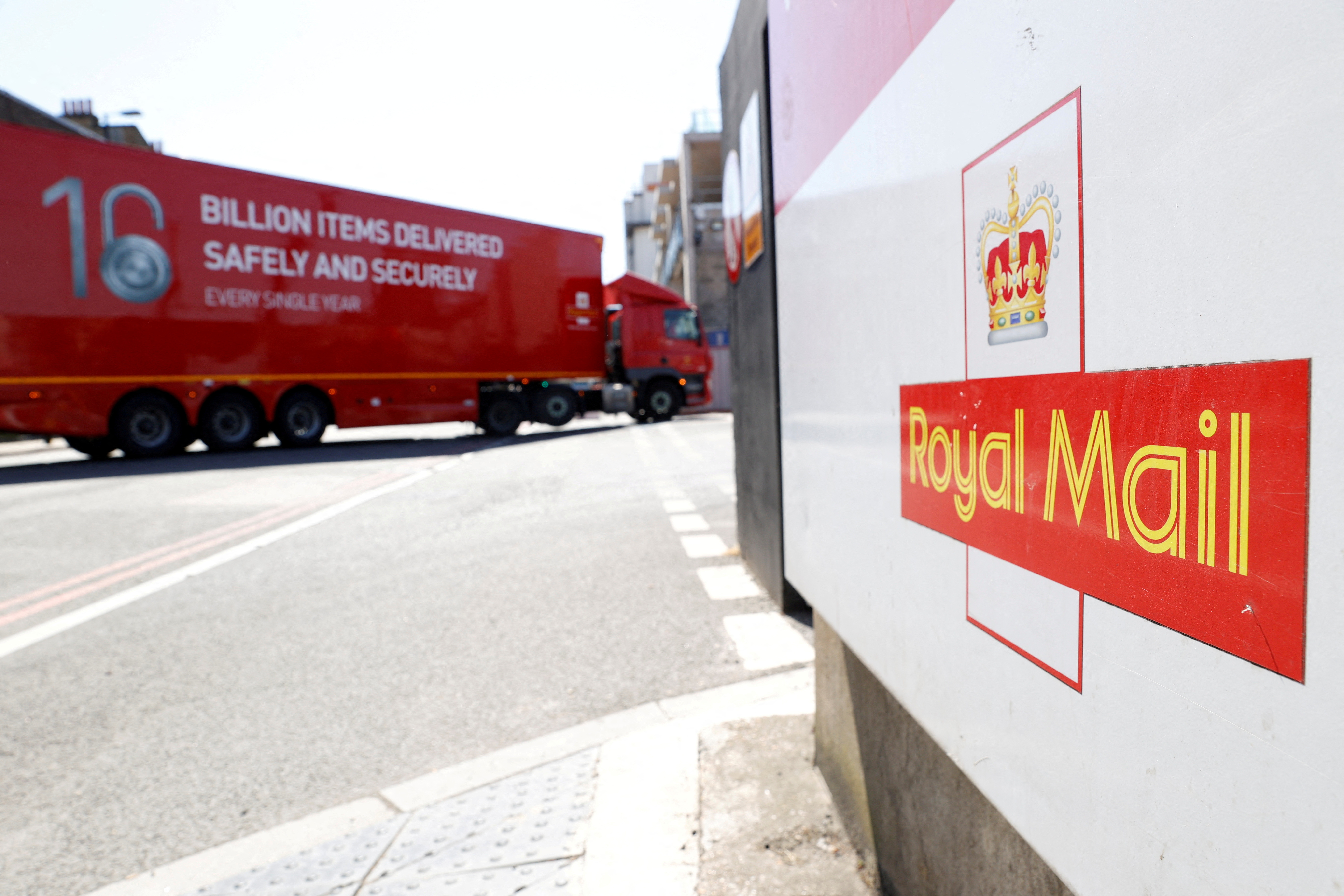 The logo of Royal Mail is seen outside the Mount Pleasant Sorting Office as a delivery vehicle arrives, in London