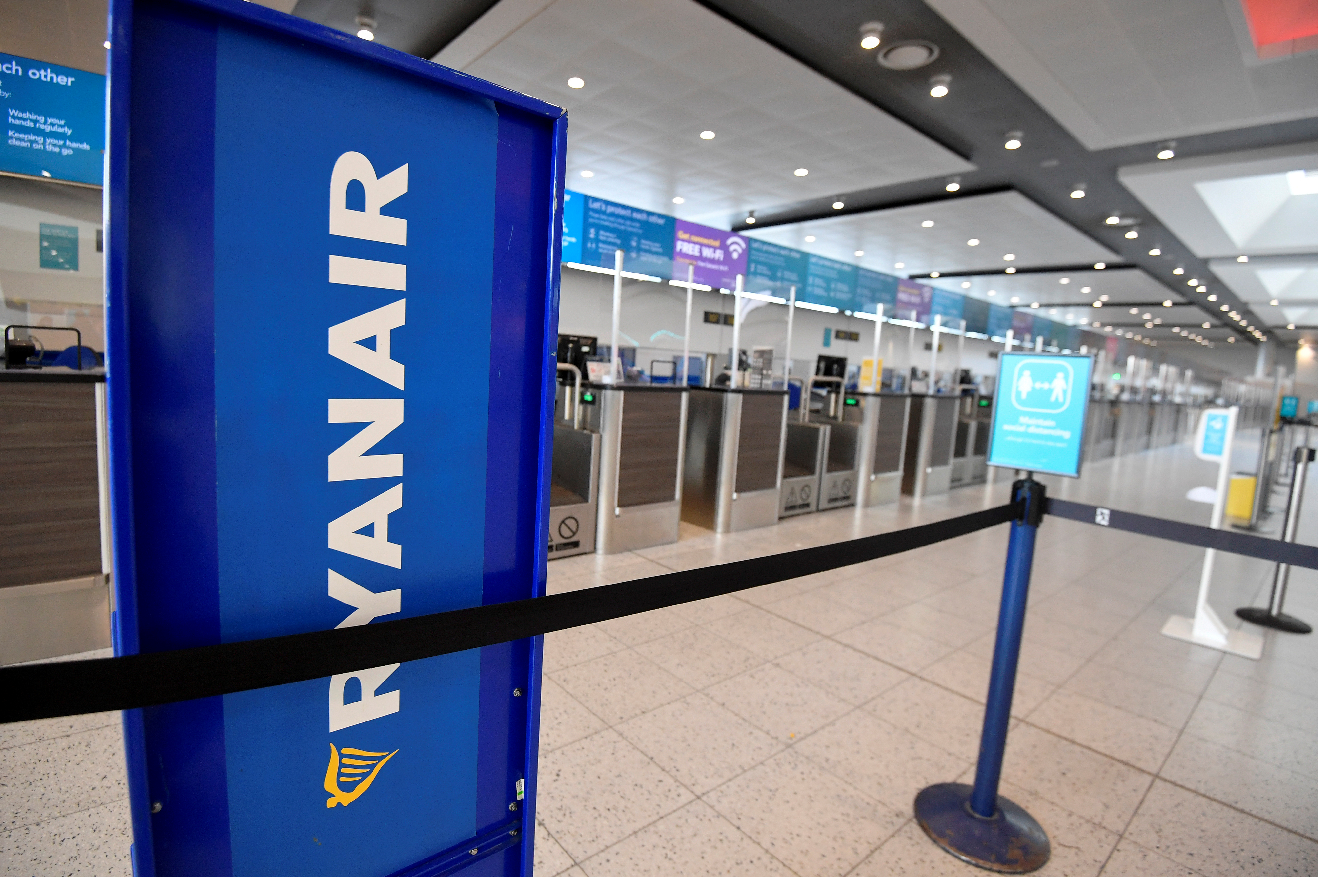 Ryanair sign is seen at the check-in area at Gatwick Airport, in Gatwick
