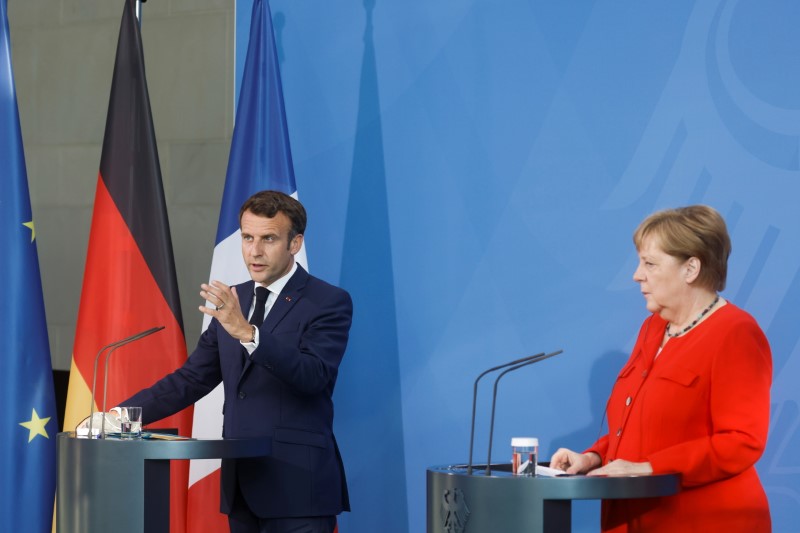 German Chancellor Angela Merkel and French President Emmanuel Macron give a news statement in Berlin