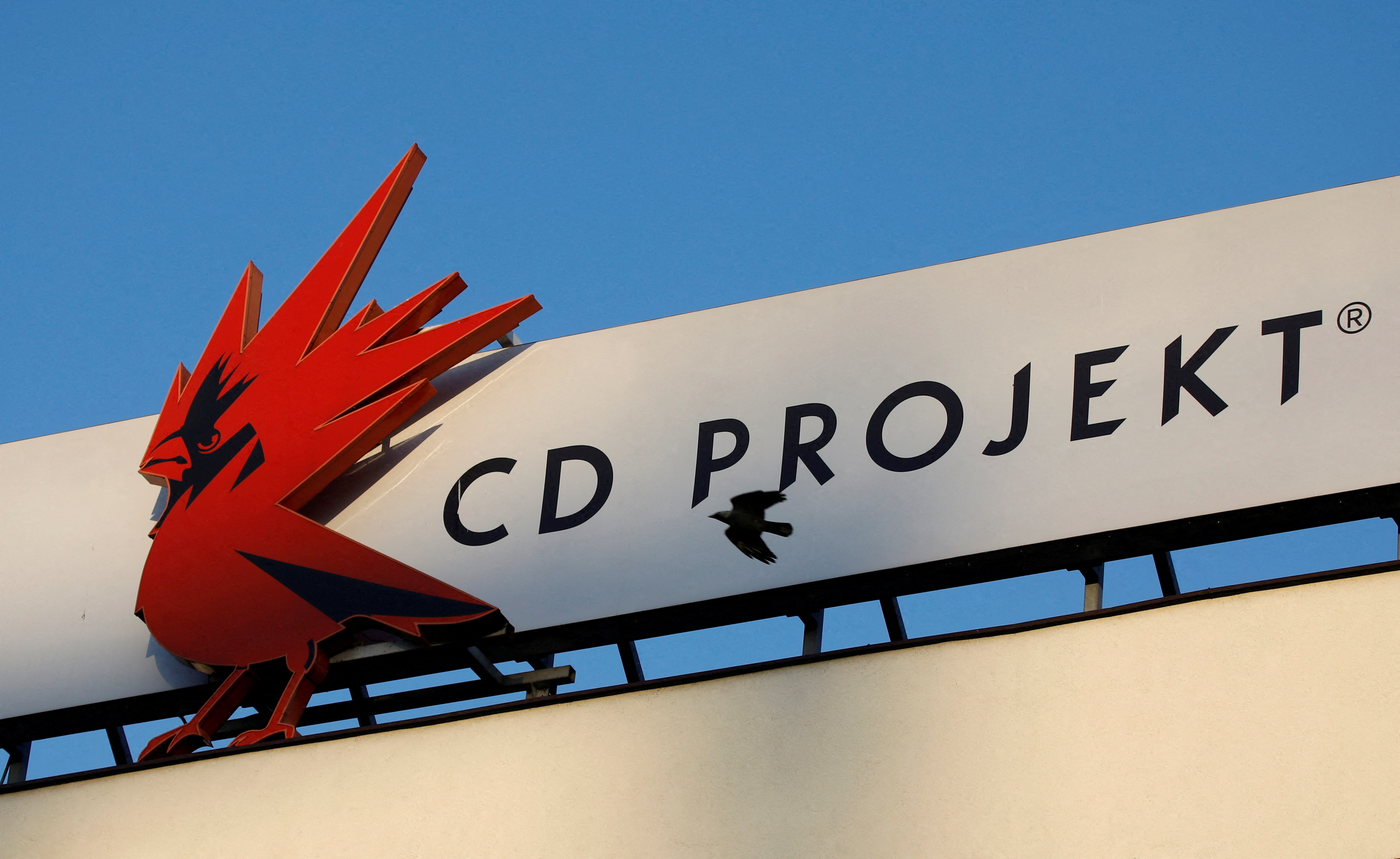 FILE PHOTO: A bird flies in front of the CD Projekt logo at its headquarters in Warsaw