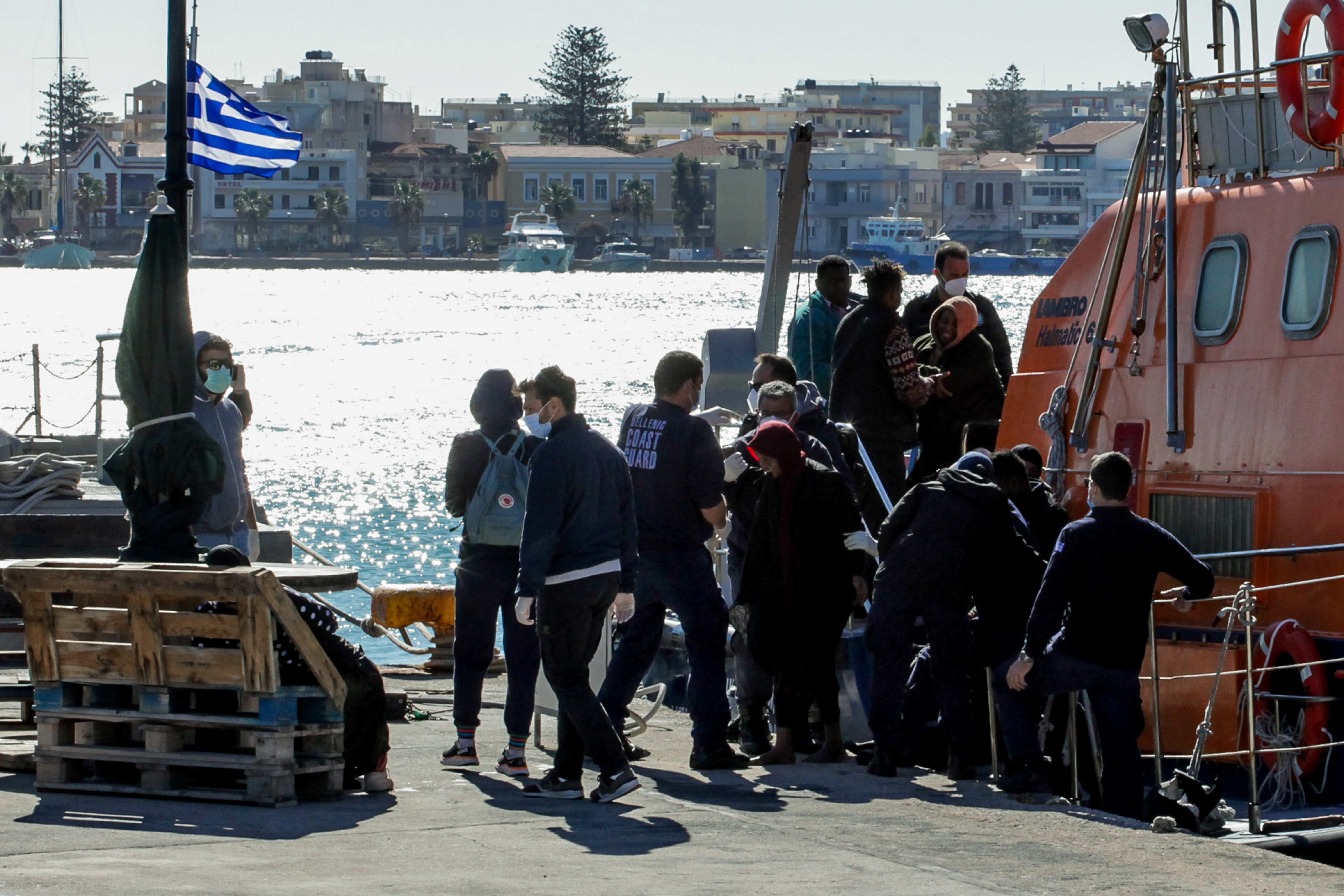 Migrants disembark a Hellenic Coast Guard vessel after being rescued at open sea, on the island of Chios, Greece, October 26, 2021. Dimitris Vouchouris/Eurokinissi via REUTERS 
