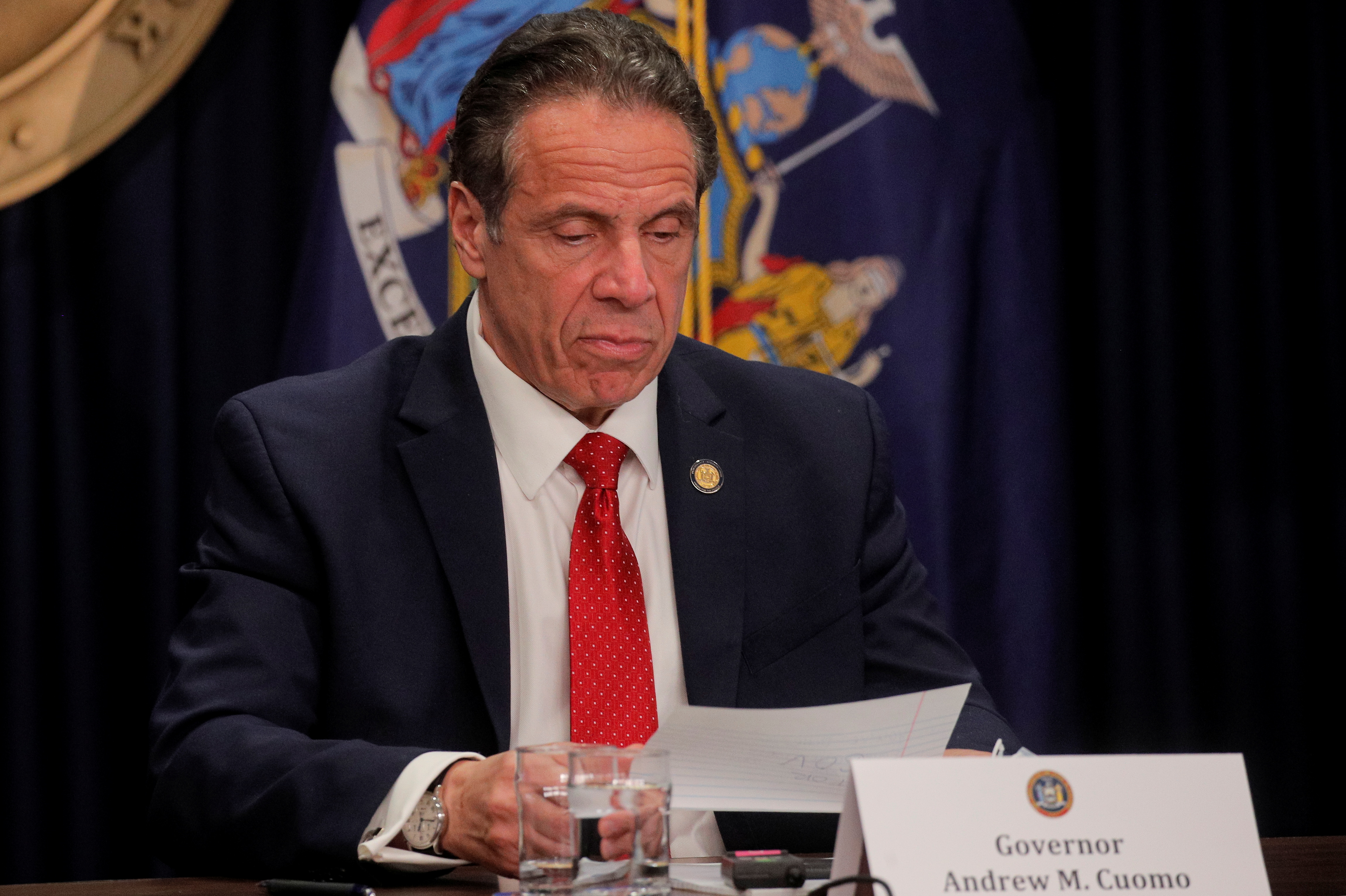 New York Governor Andrew Cuomo reads a note during a news conference at his offices in New York