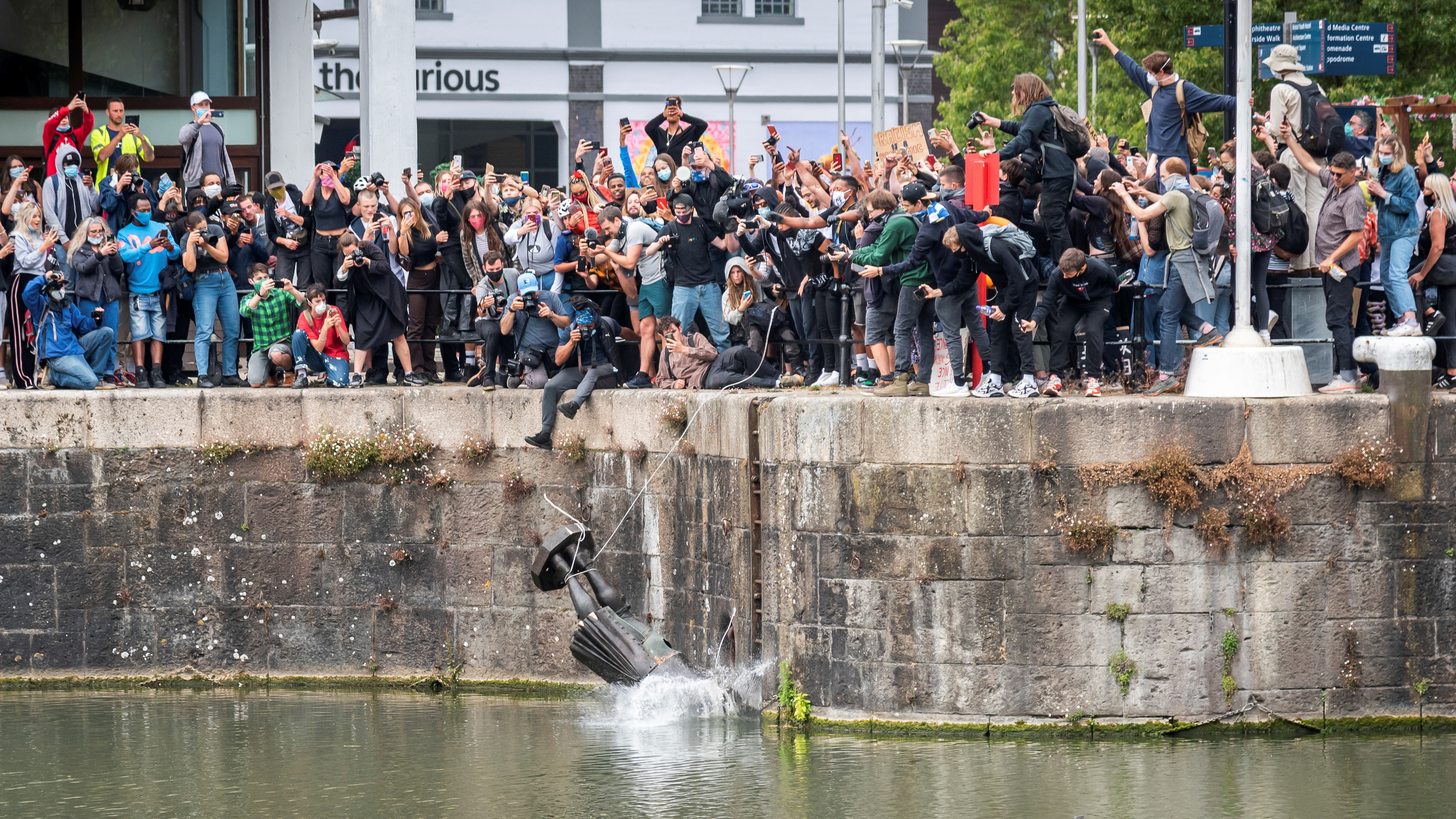 The statue of Edward Colston falls into the water after protesters pulled it down in Bristol