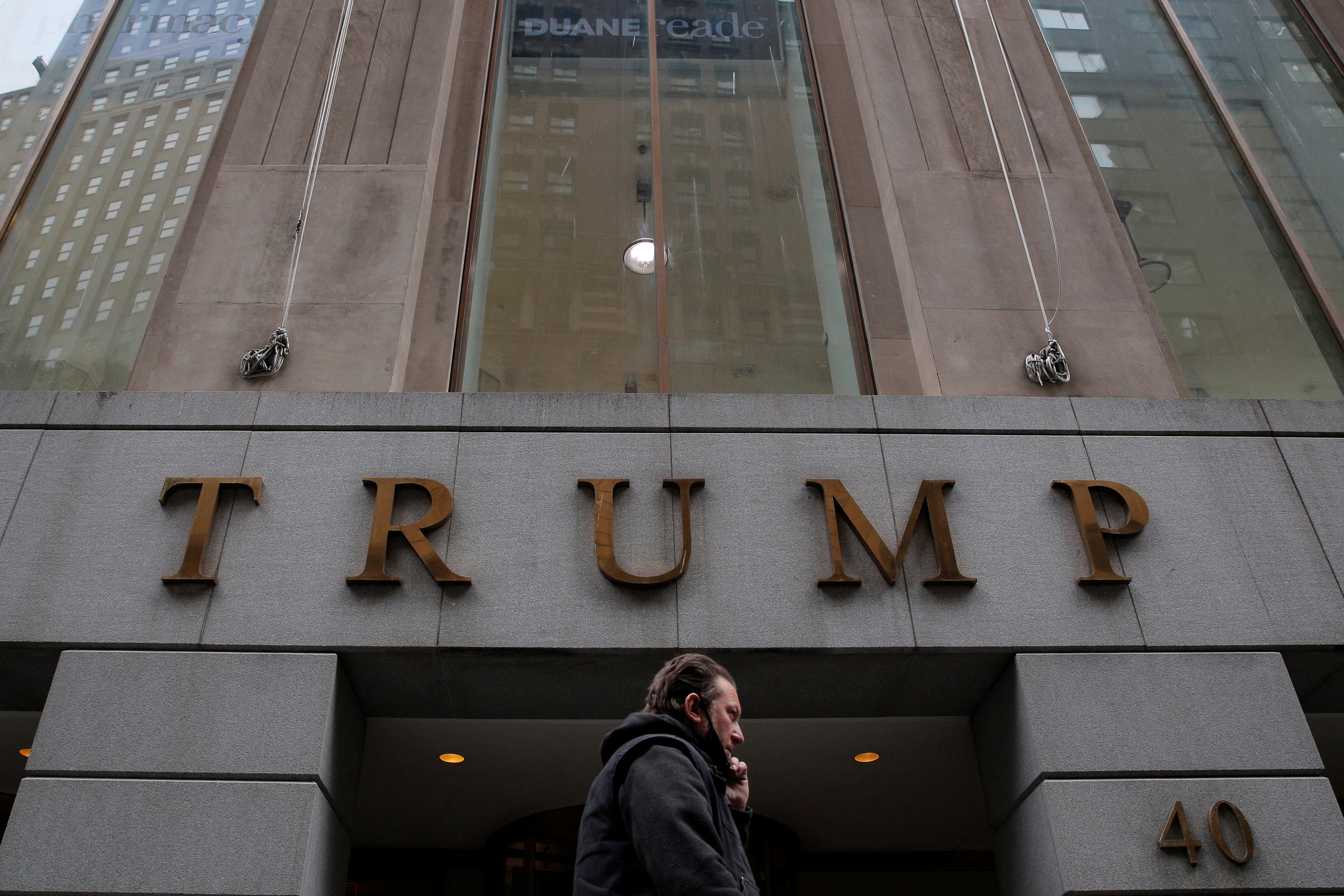 A woman walks past 40 Wall Street, also known as the Trump Building, in the Manhattan borough of New York