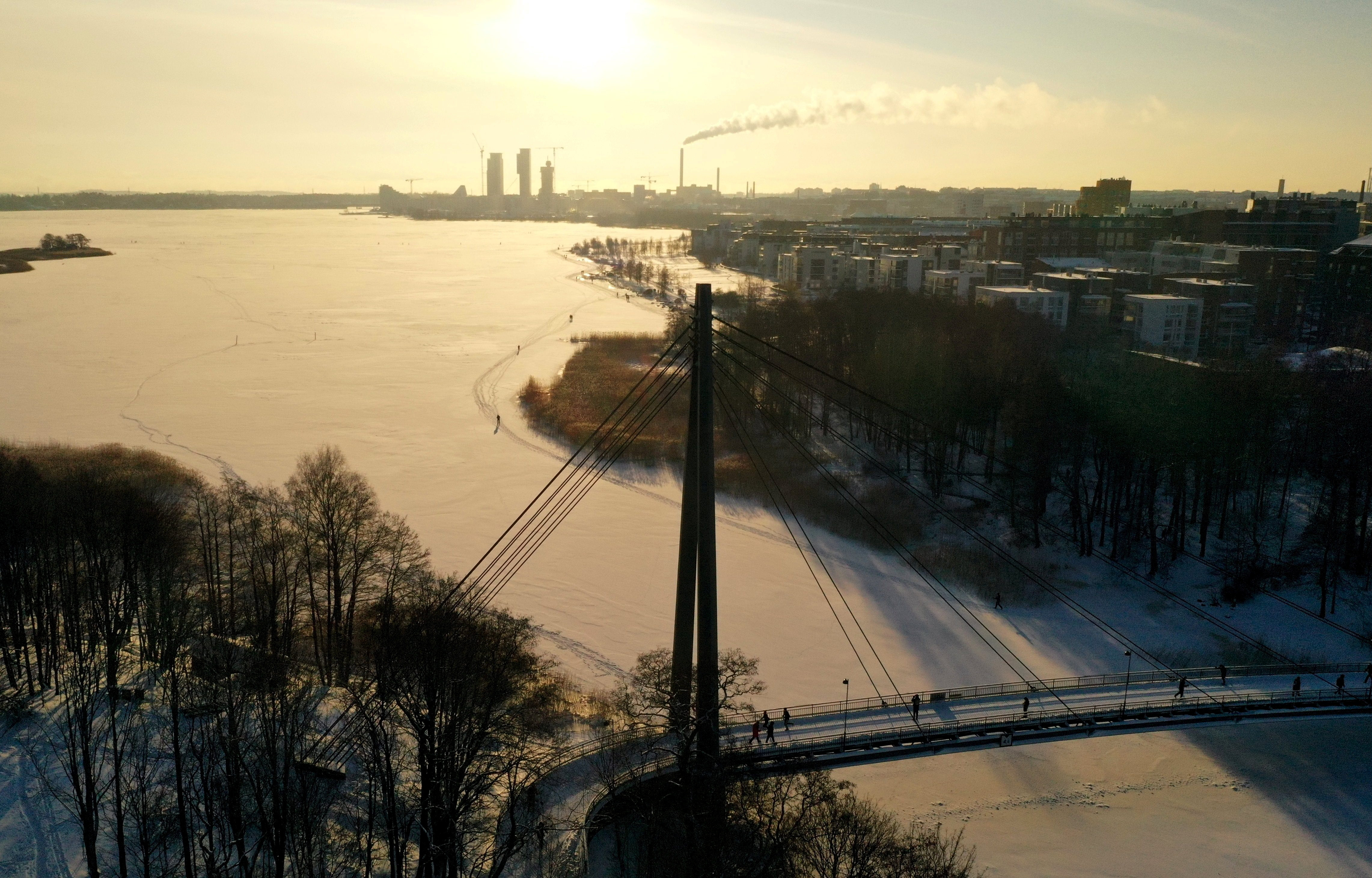 People walk during sunny weather in Helsinki